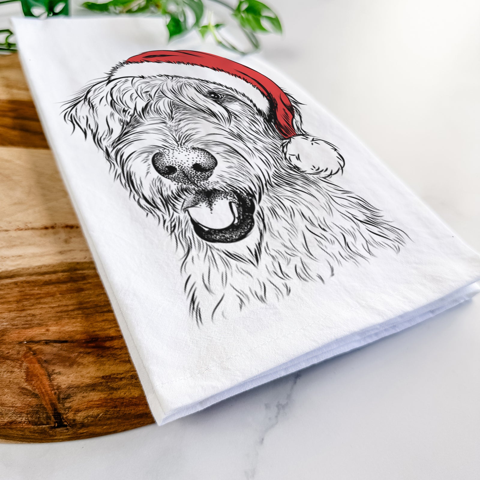 Hand-drawn sketch of Ragnar the Irish Wolfhound wearing a Santa hat on a tea towel