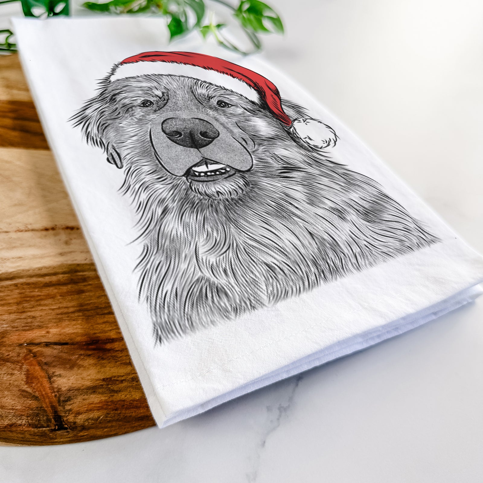 Hand-drawn sketch of Ralph the Leonberger wearing a Santa hat on a tea towel