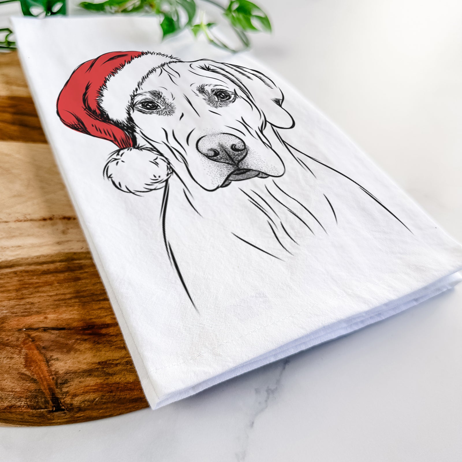 Hand-drawn sketch of Reid the Rhodesian Ridgeback wearing a Santa hat on a tea towel