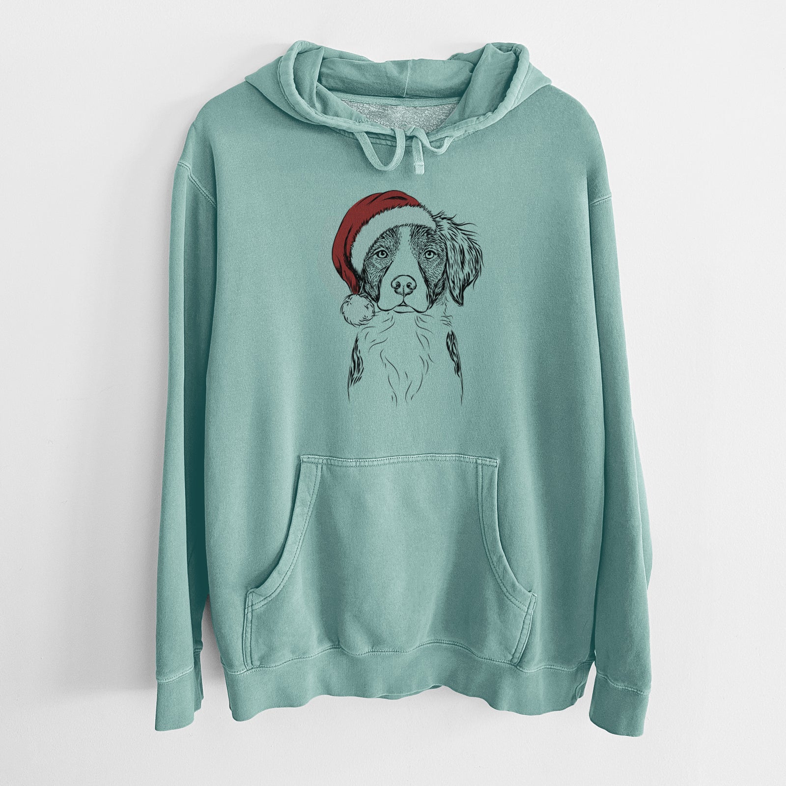 Hand-drawn sketch of Remi the Brittany wearing a Santa hat on a Mint Unisex pigment dyed hoodie