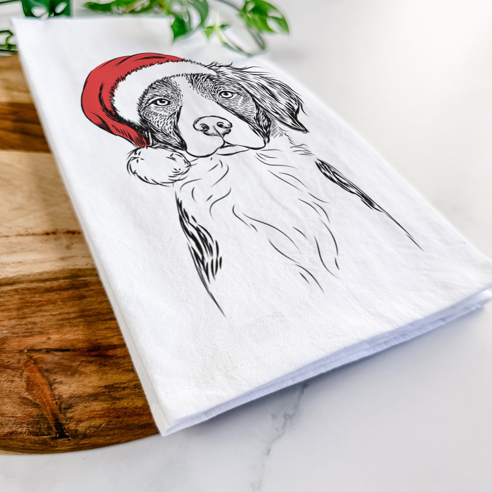 Hand-drawn sketch of Remi the Brittany wearing a Santa hat on a tea towel