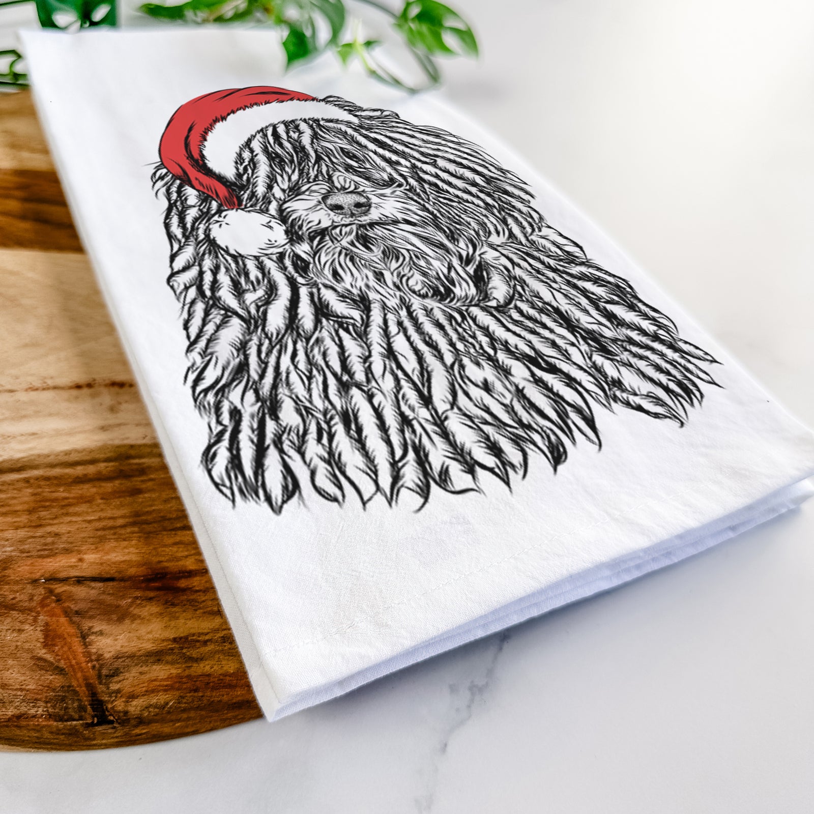 Hand-drawn sketch of Rezi the Puli wearing a Santa hat on a tea towel