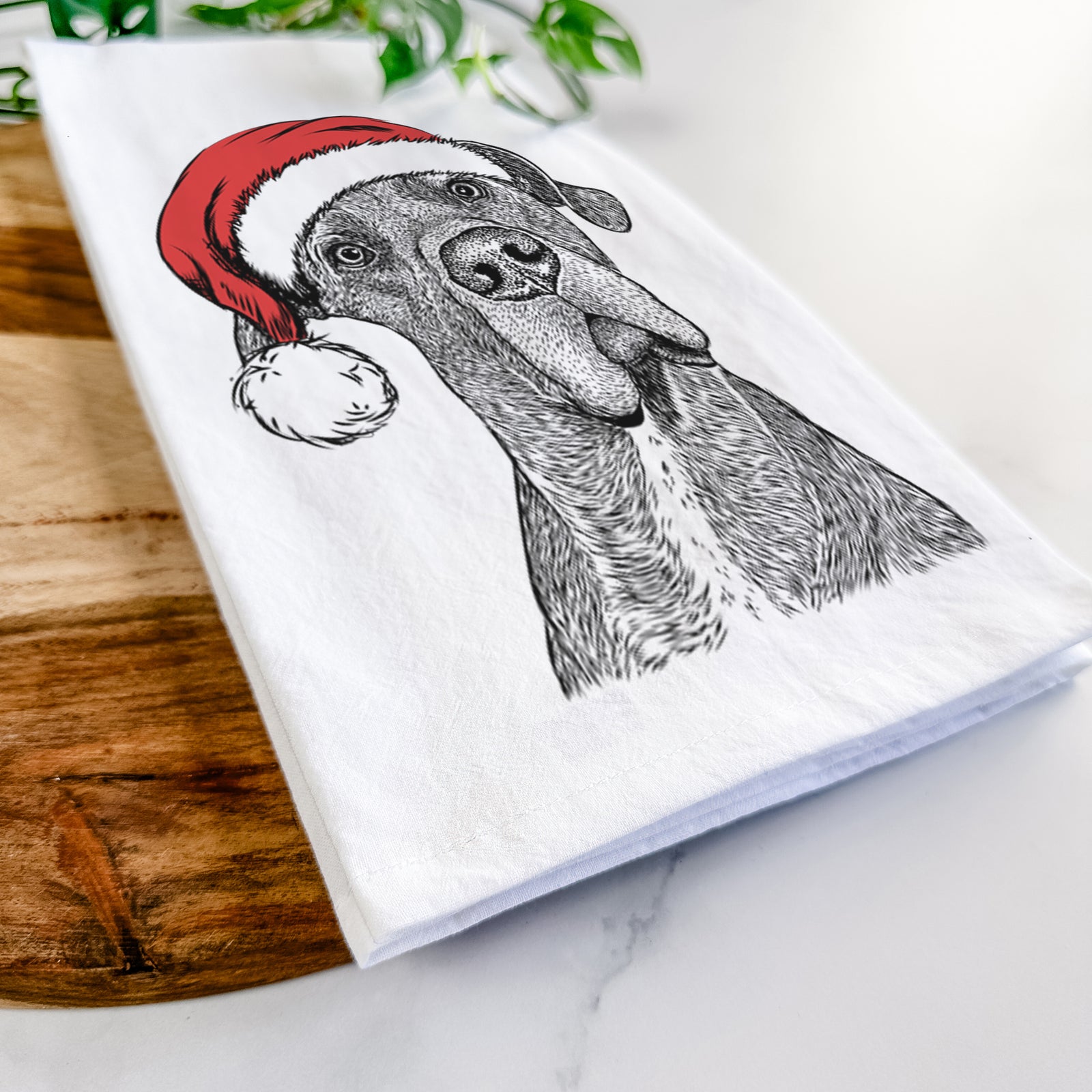 Hand-drawn sketch of River the Great Dane wearing a Santa hat on a tea towel
