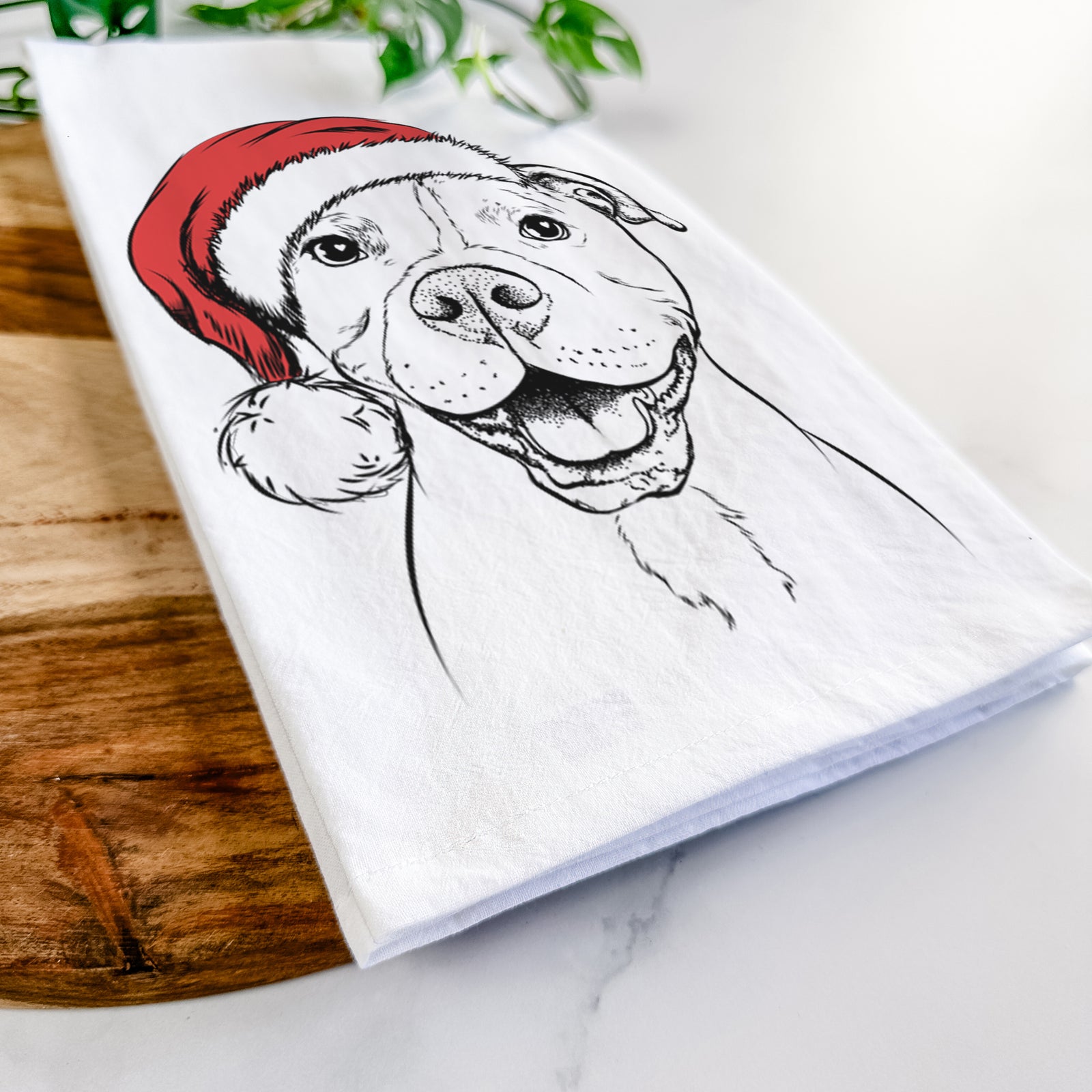 Hand-drawn sketch of Roscoe the Pitbull wearing a Santa hat on a tea towel