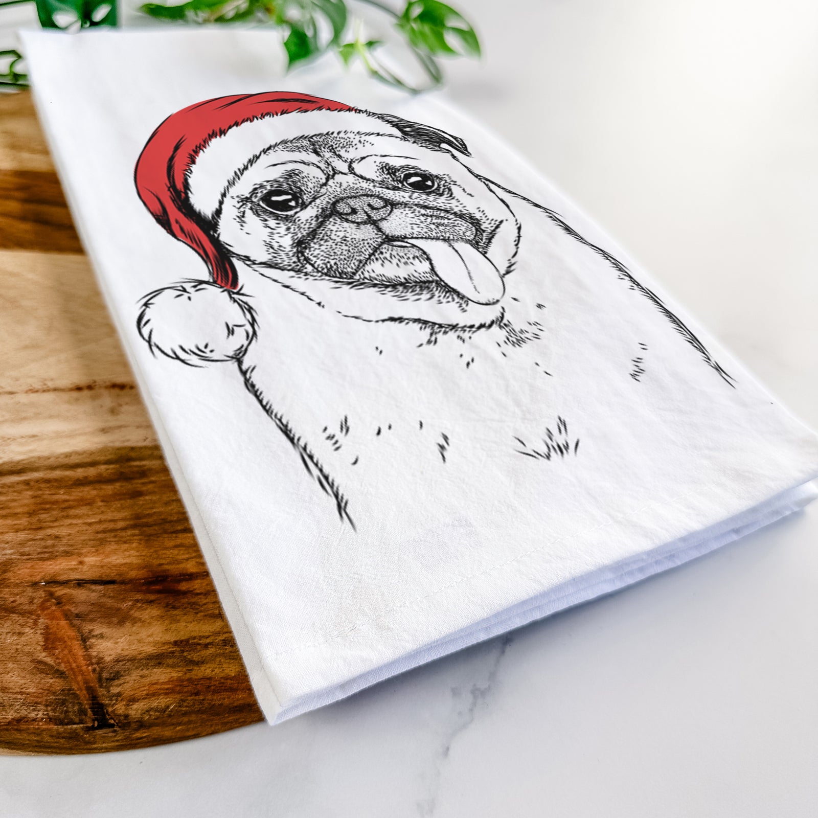 Hand-drawn sketch of Rosie the Pug wearing a Santa hat on a tea towel