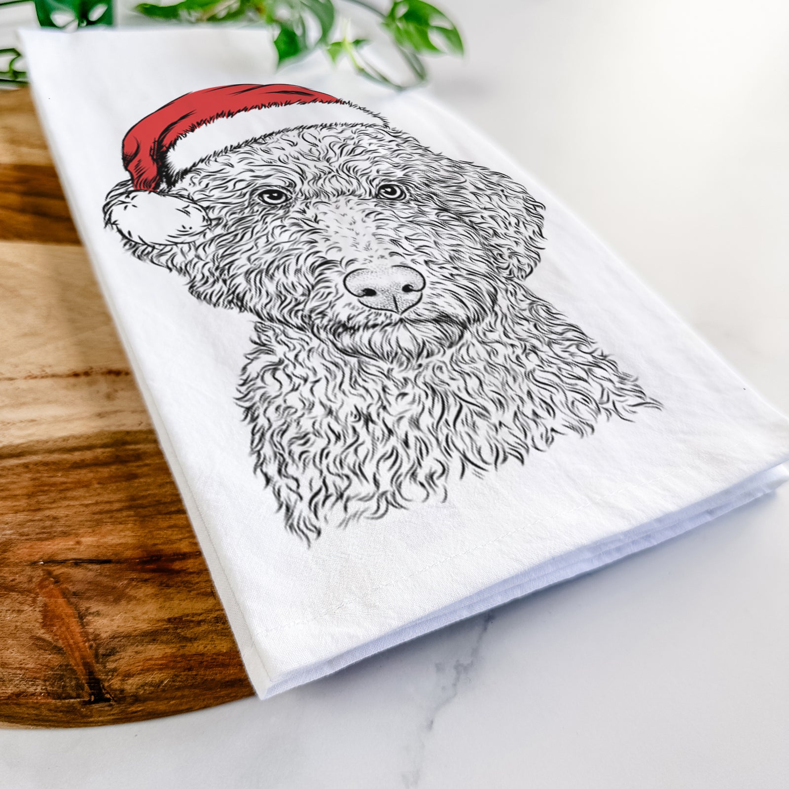 Hand-drawn sketch of Ross the Lagotto Romagnolo wearing a Santa hat on a tea towel