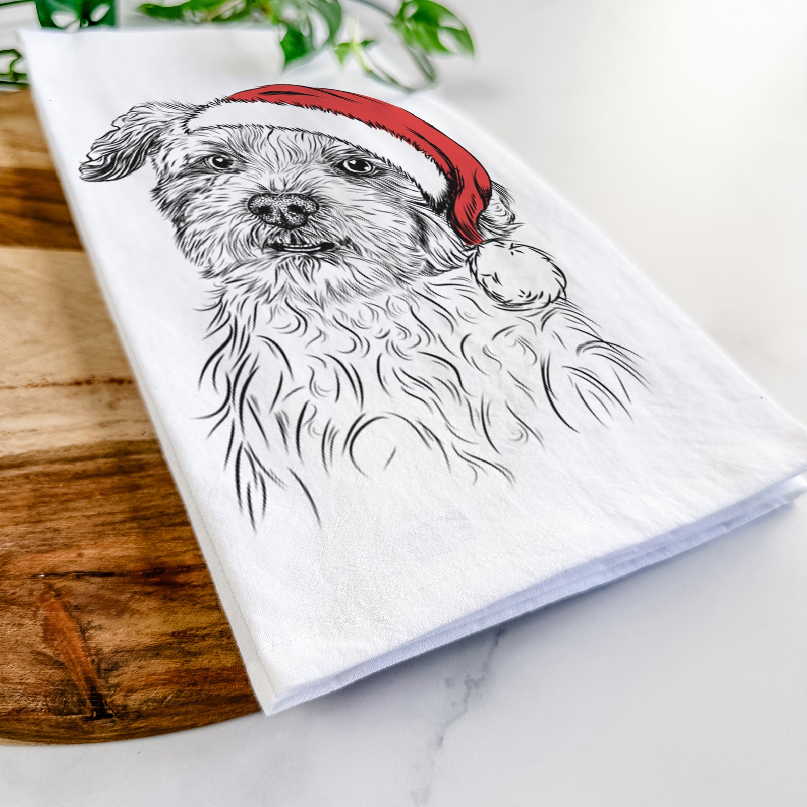 Hand-drawn sketch of Roxie the Schnauzer Shih Tzu Mix wearing a Santa hat on a tea towel