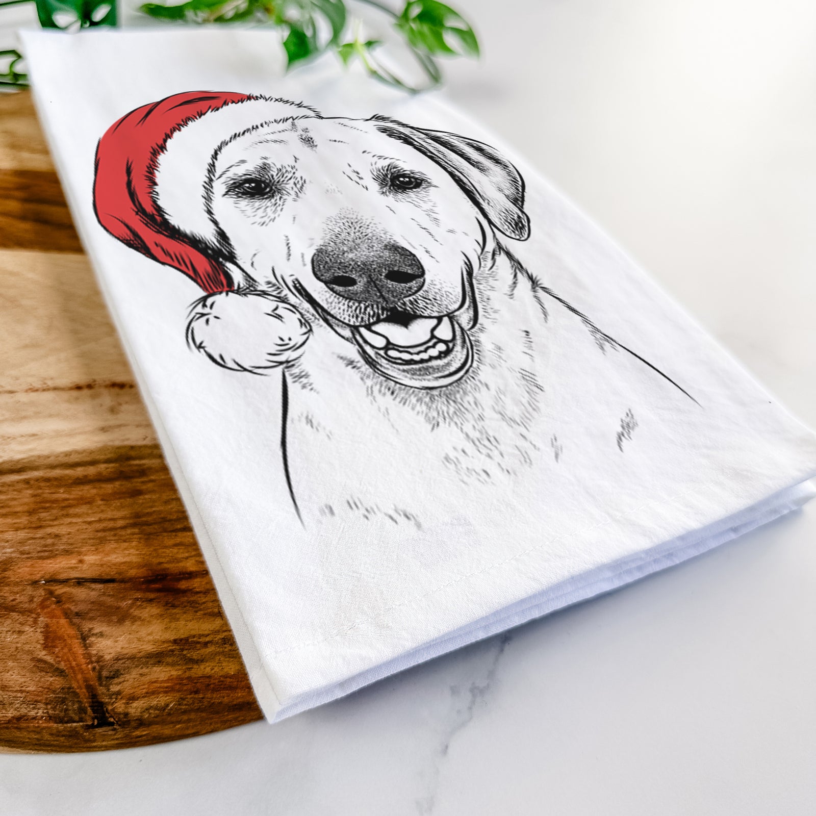 Hand-drawn sketch of Rusty the Labrador Retriever wearing a Santa hat on a tea towel