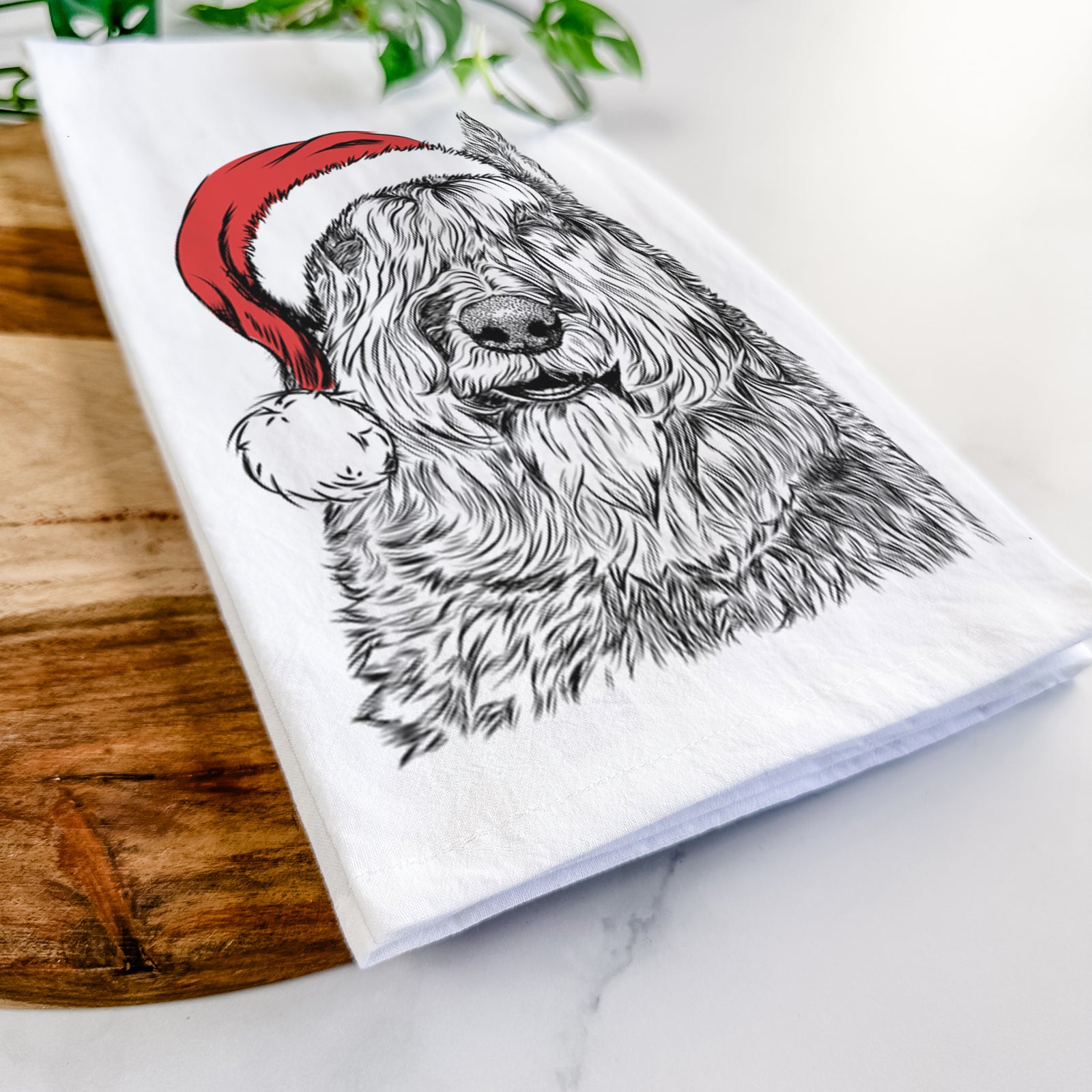 Hand-drawn sketch of Sabre the Bouvier Des Flandres wearing a Santa hat on a tea towel