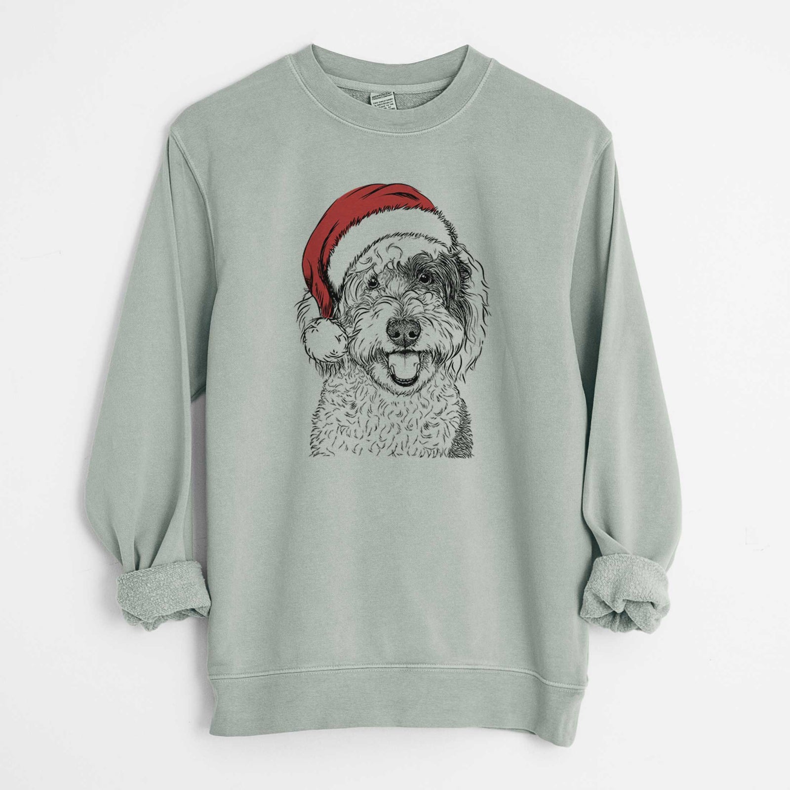 Hand-drawn sketch of Sherlock the Sheepadoodle wearing a Santa hat on a Sage Unisex pigment dyed crew sweatshirt