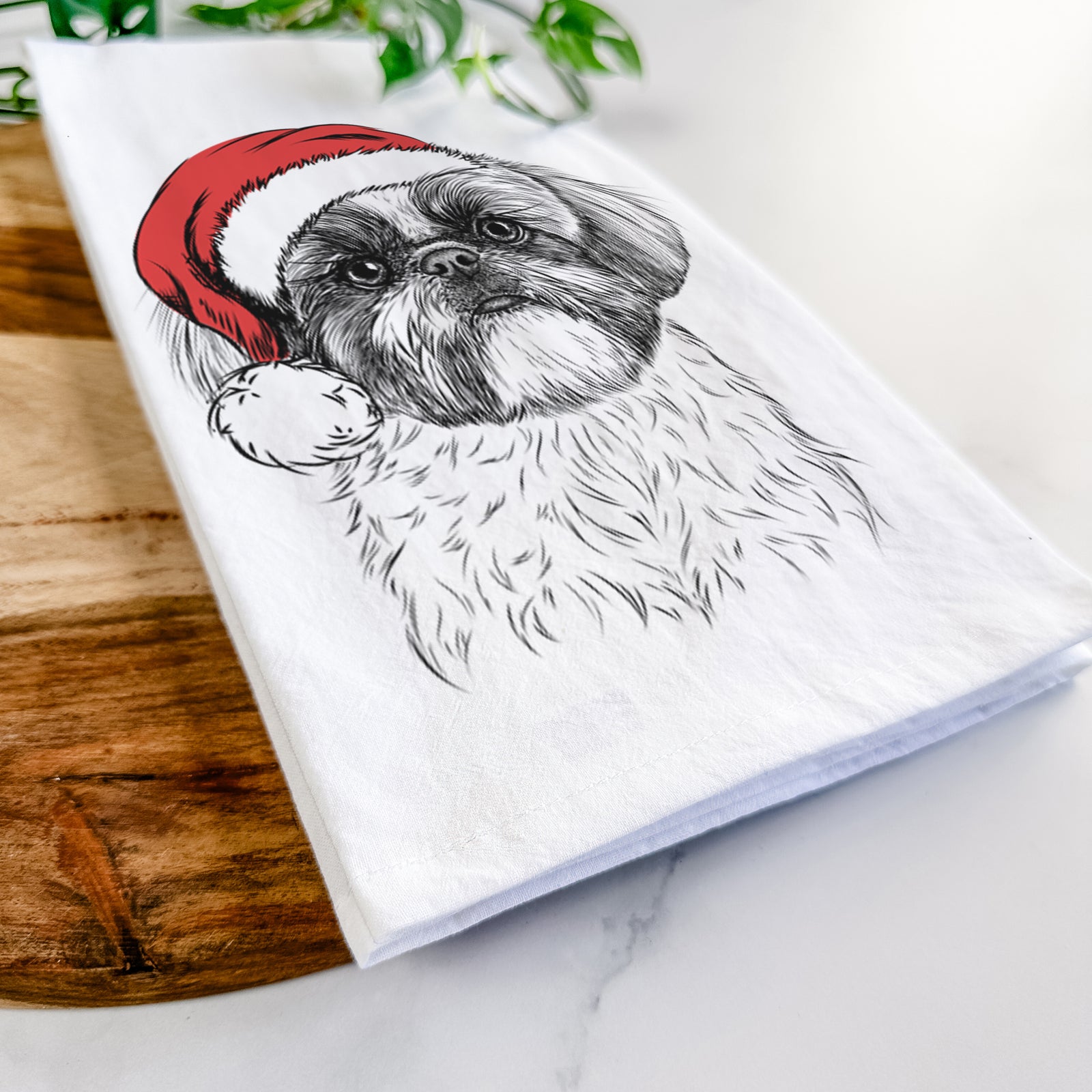 Hand-drawn sketch of Simon the Shih Tzu wearing a Santa hat on a tea towel