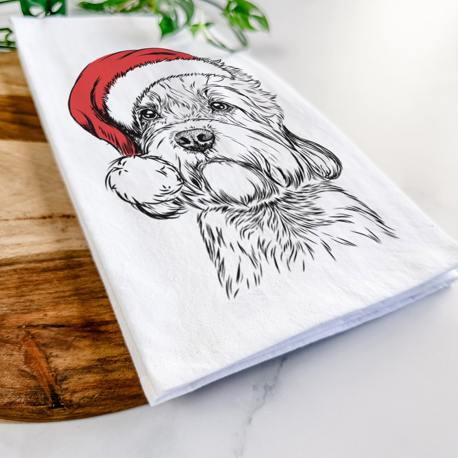 Hand-drawn sketch of Sir Walter the Dandie Dinmont Terrier wearing a Santa hat on a tea towel