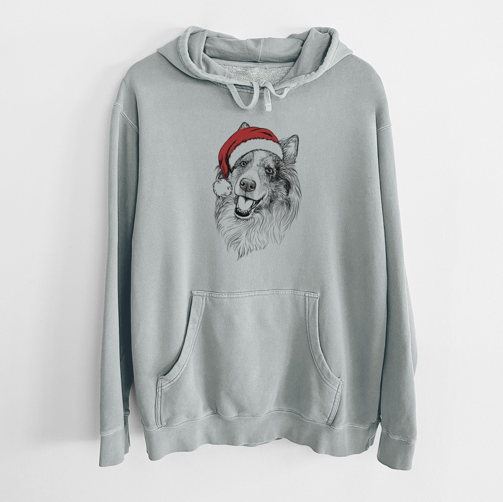 Hand-drawn sketch of Skylar the Shetland Sheepdog wearing a Santa hat on a Sage Unisex pigment dyed hoodie