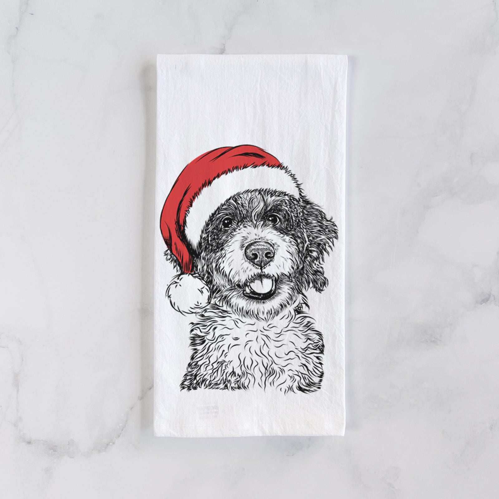 Hand-drawn sketch of Smoky the Bernedoodle Puppy wearing a Santa hat on a tea towel