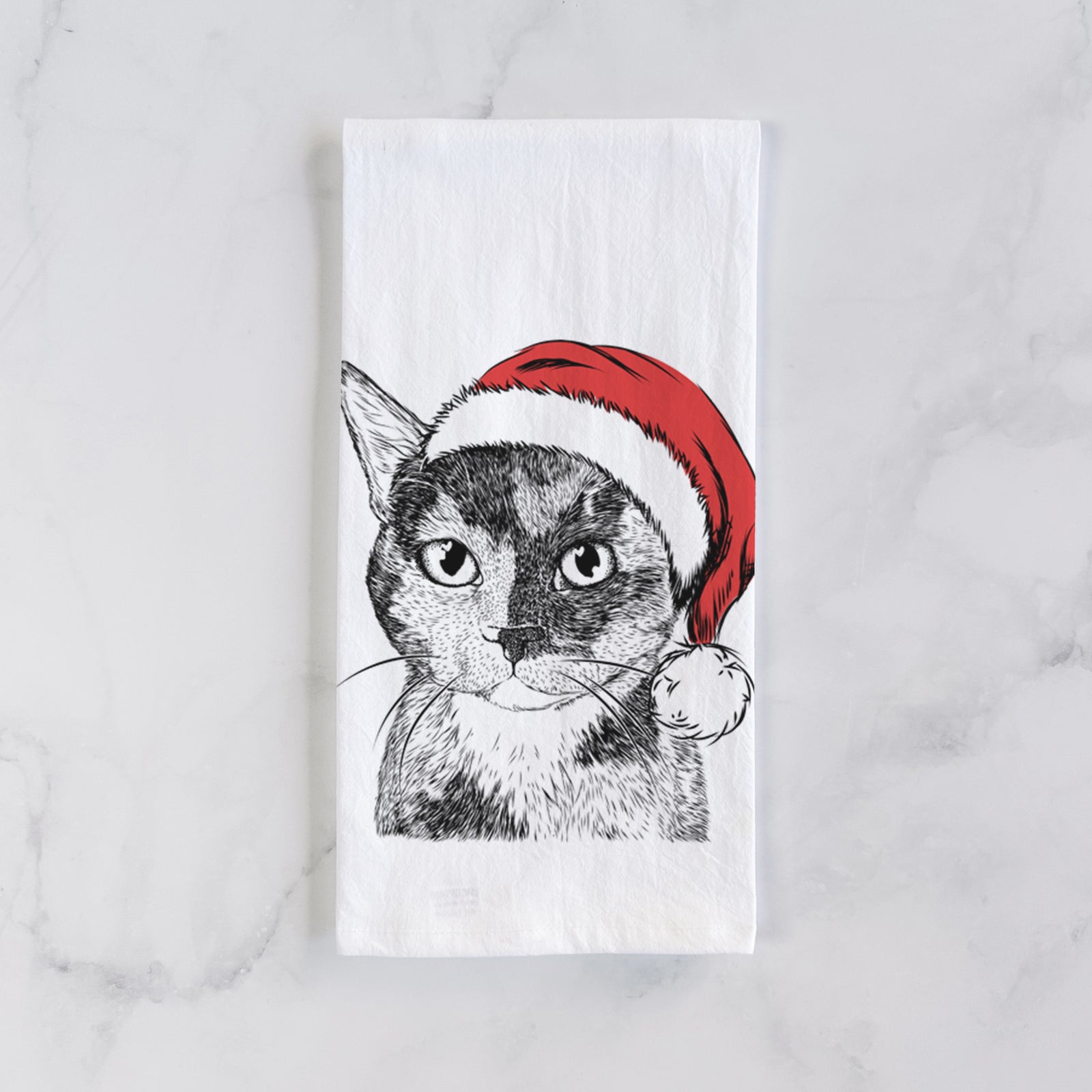 Hand-drawn sketch of Spooky Kitty the Tortoiseshell Cat wearing a Santa hat on a tea towel