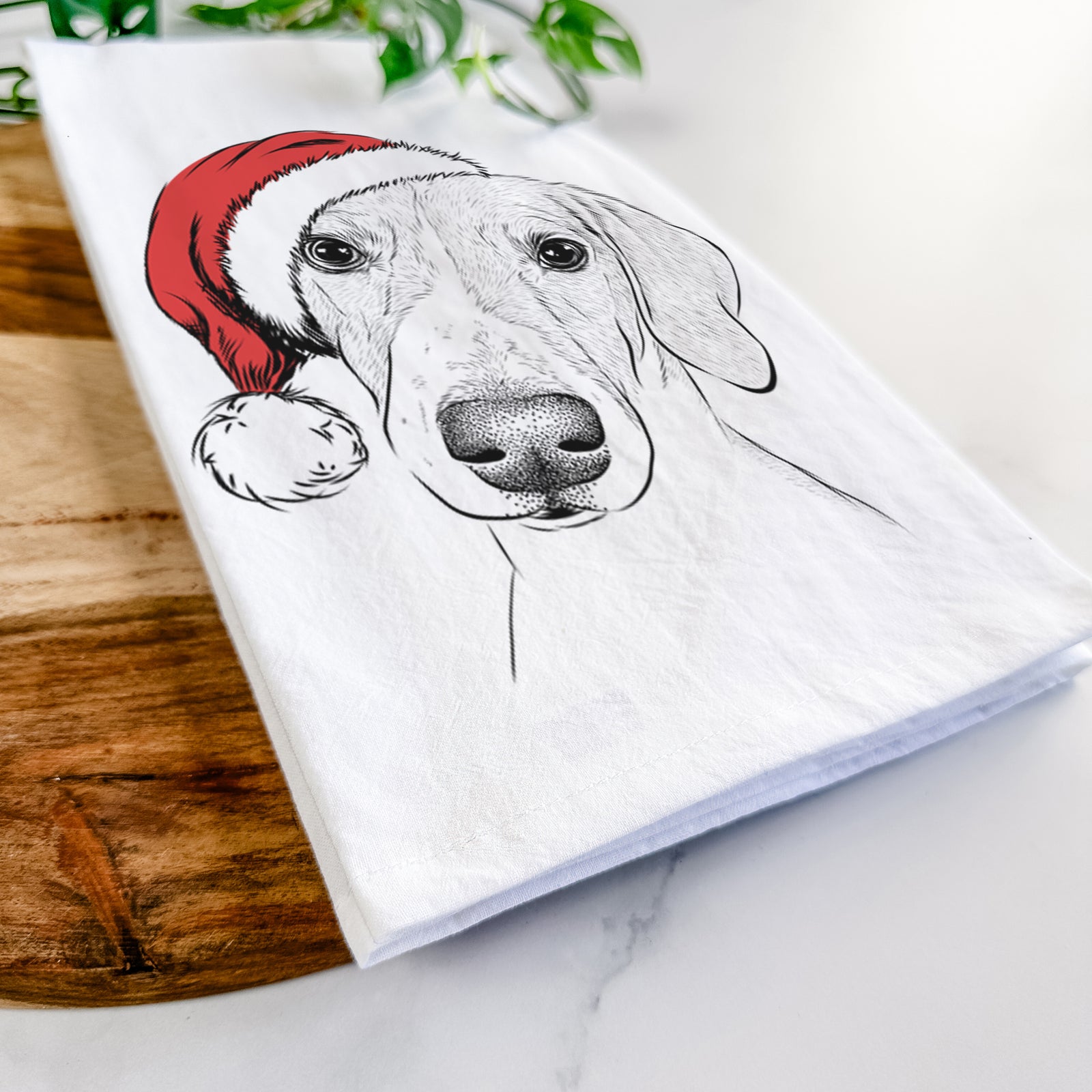 Hand-drawn sketch of Stanley the Foxhound wearing a Santa hat on a tea towel