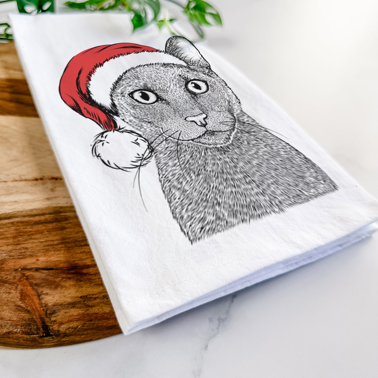 Hand-drawn sketch of Stanley the Russian Blue Cat wearing a Santa hat on a tea towel