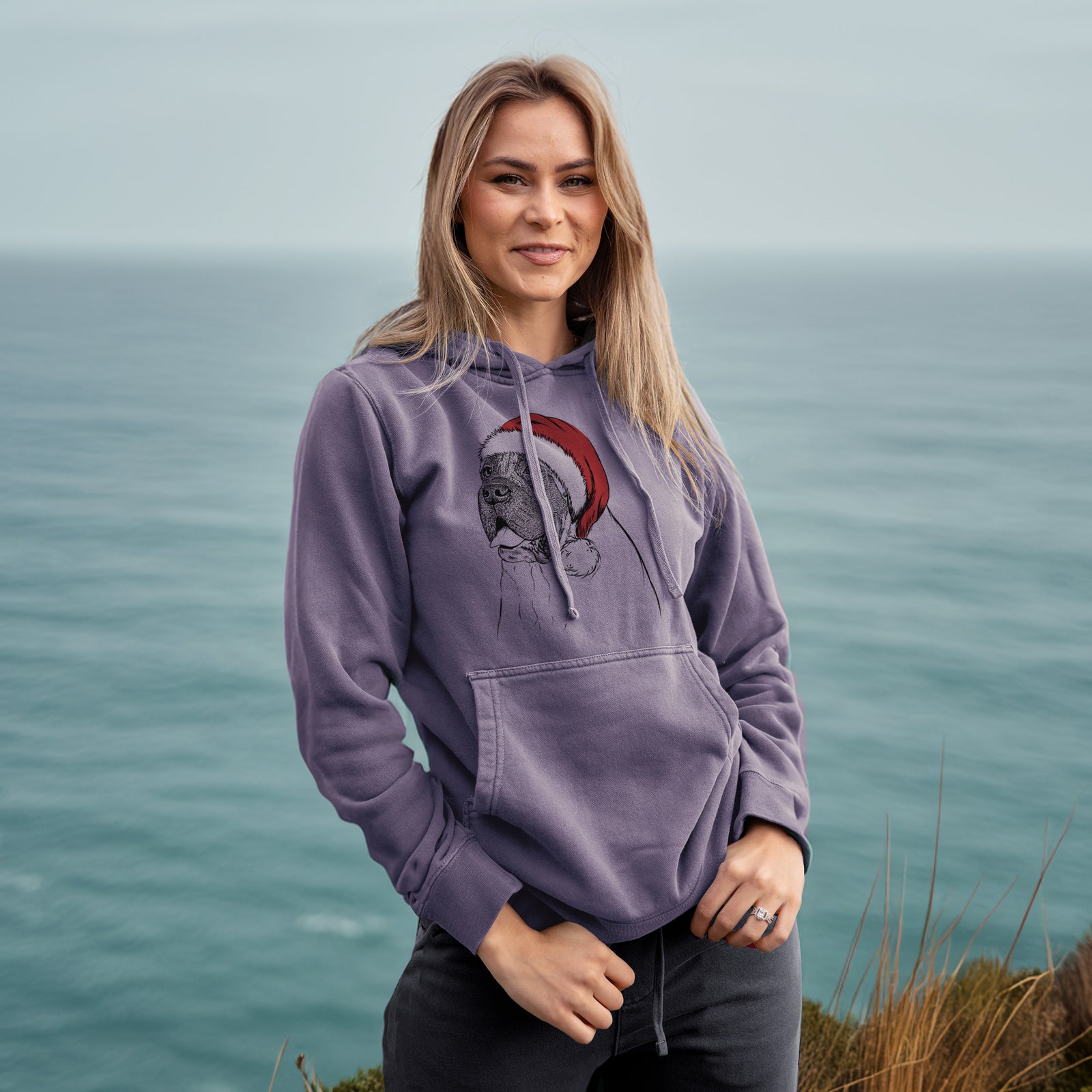Hand-drawn sketch of Sterling the English Mastiff wearing a Santa hat on a Plum Unisex pigment dyed hoodie, worn by a woman