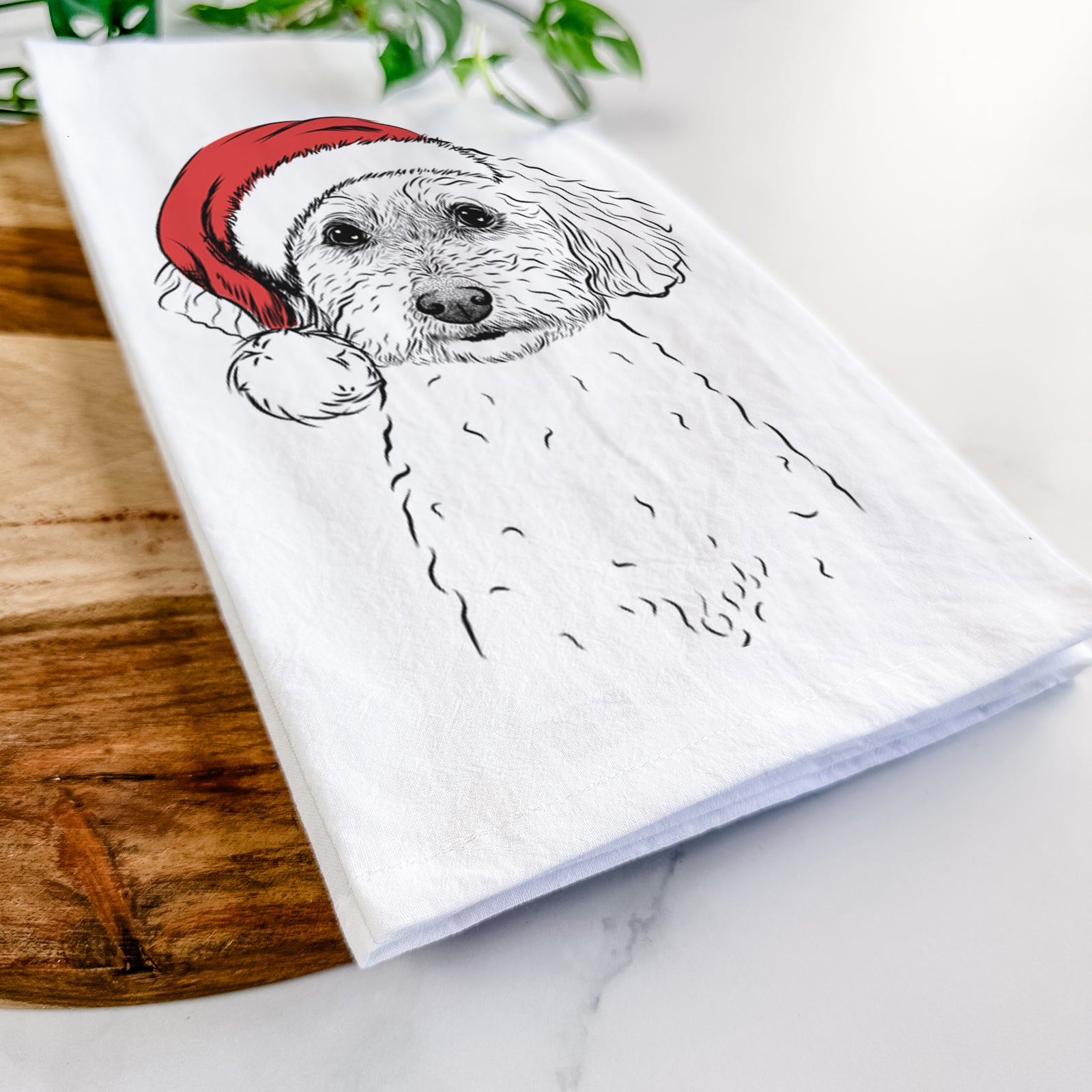 Hand-drawn sketch of Stitch the Bichonpoo wearing a Santa hat on a tea towel