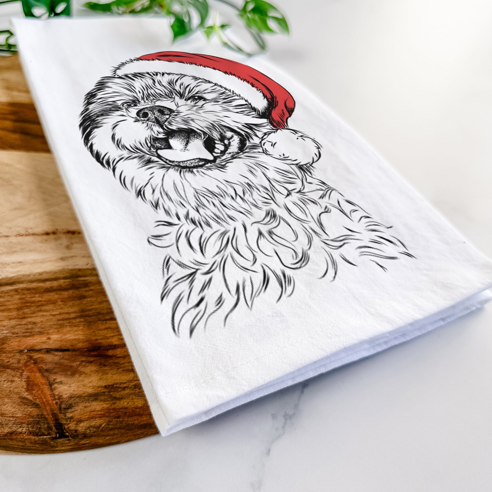 Hand-drawn sketch of Sugar the Malshi wearing a Santa hat on a tea towel