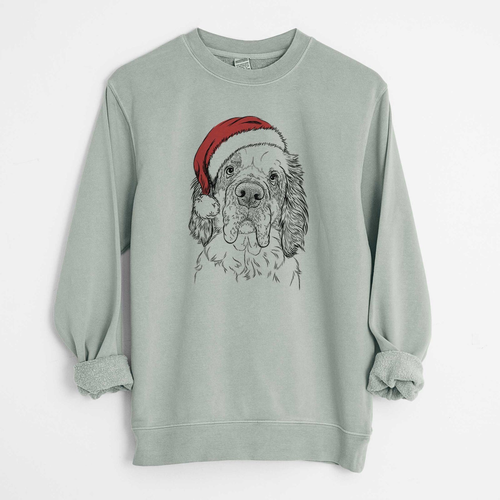 Hand-drawn sketch of Sully the Clumber Spaniel wearing a Santa hat on a Sage Unisex pigment dyed crew sweatshirt