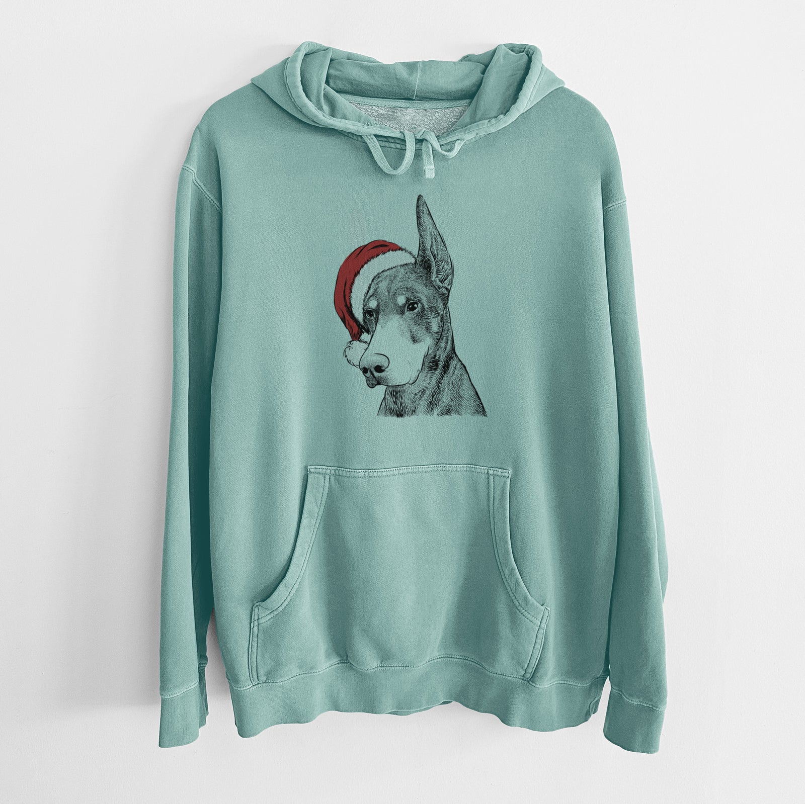 Hand-drawn sketch of Sunny the Doberman Pinscher wearing a Santa hat on a Mint Unisex pigment dyed hoodie