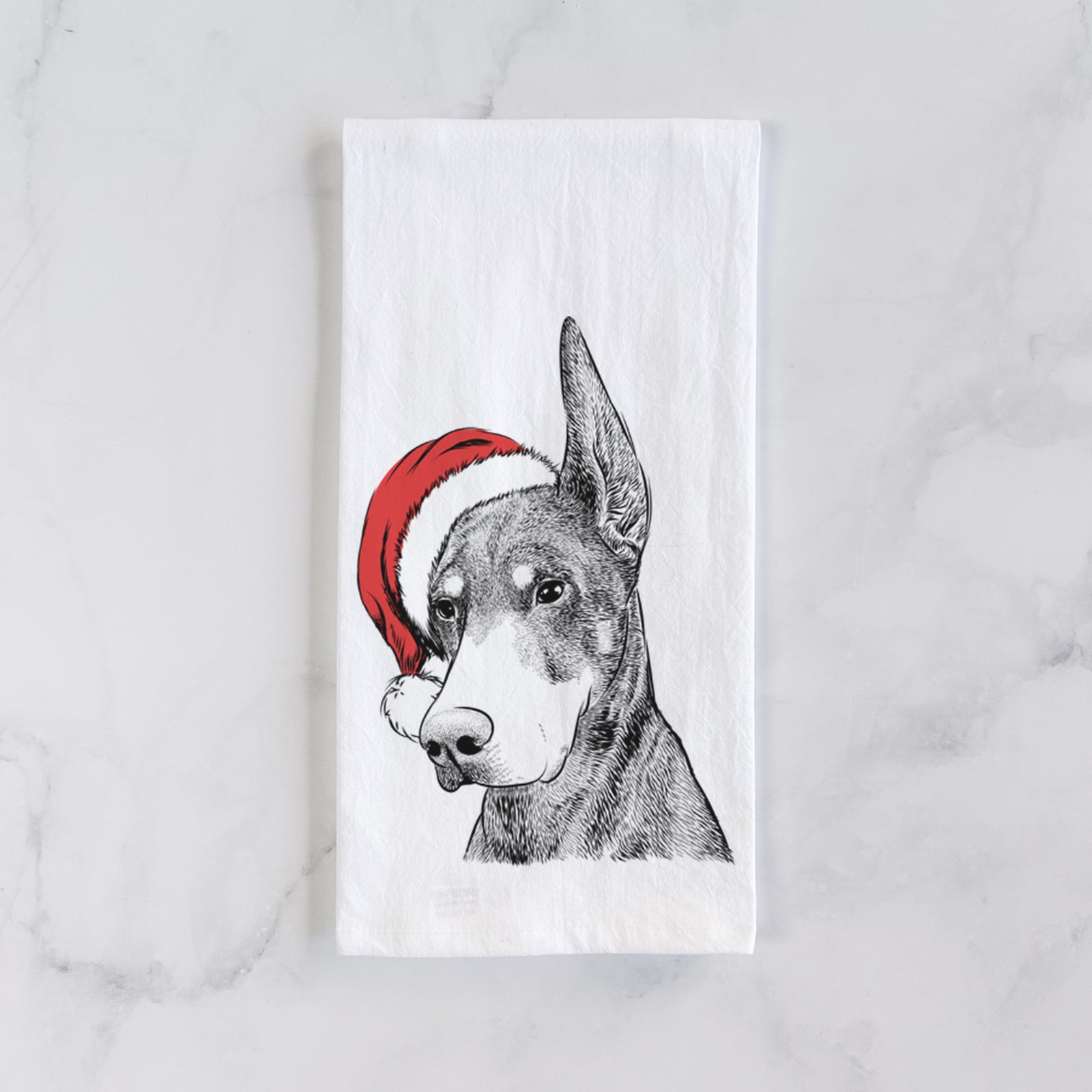 Hand-drawn sketch of Sunny the Doberman Pinscher wearing a Santa hat on a tea towel