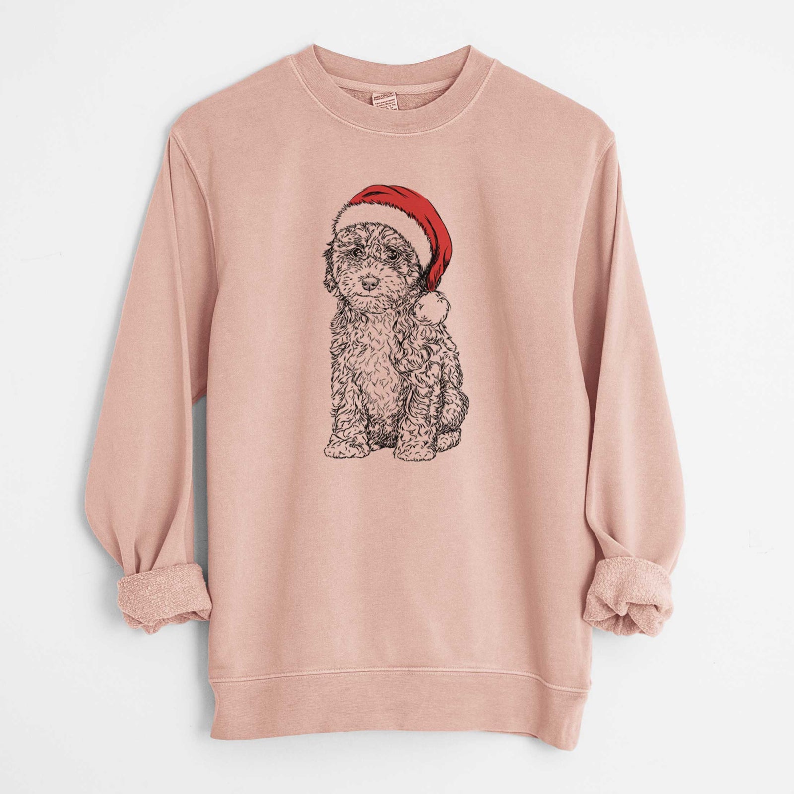 Hand-drawn sketch of Sweet Tea the Mini Doodle wearing a Santa hat on a Dusty Pink Unisex pigment dyed crew sweatshirt