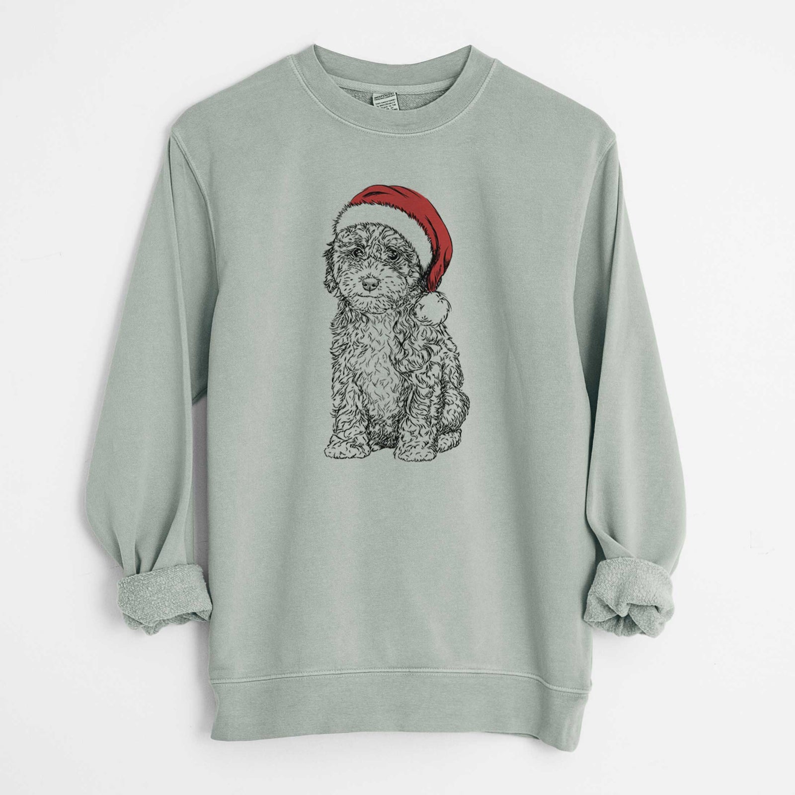 Hand-drawn sketch of Sweet Tea the Mini Doodle wearing a Santa hat on a Sage Unisex pigment dyed crew sweatshirt