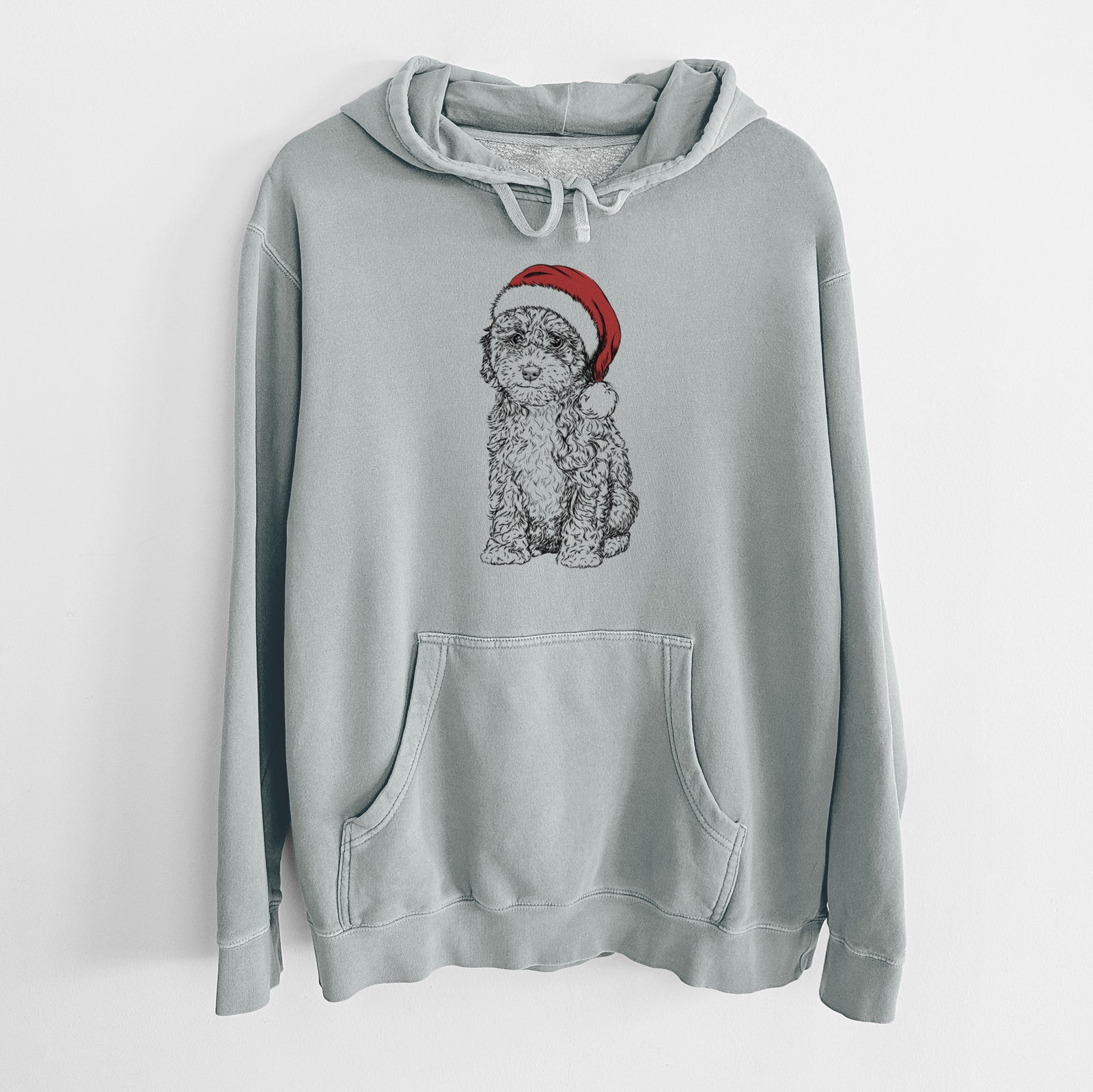 Hand-drawn sketch of Sweet Tea the Mini Doodle wearing a Santa hat on a Sage Unisex pigment dyed hoodie