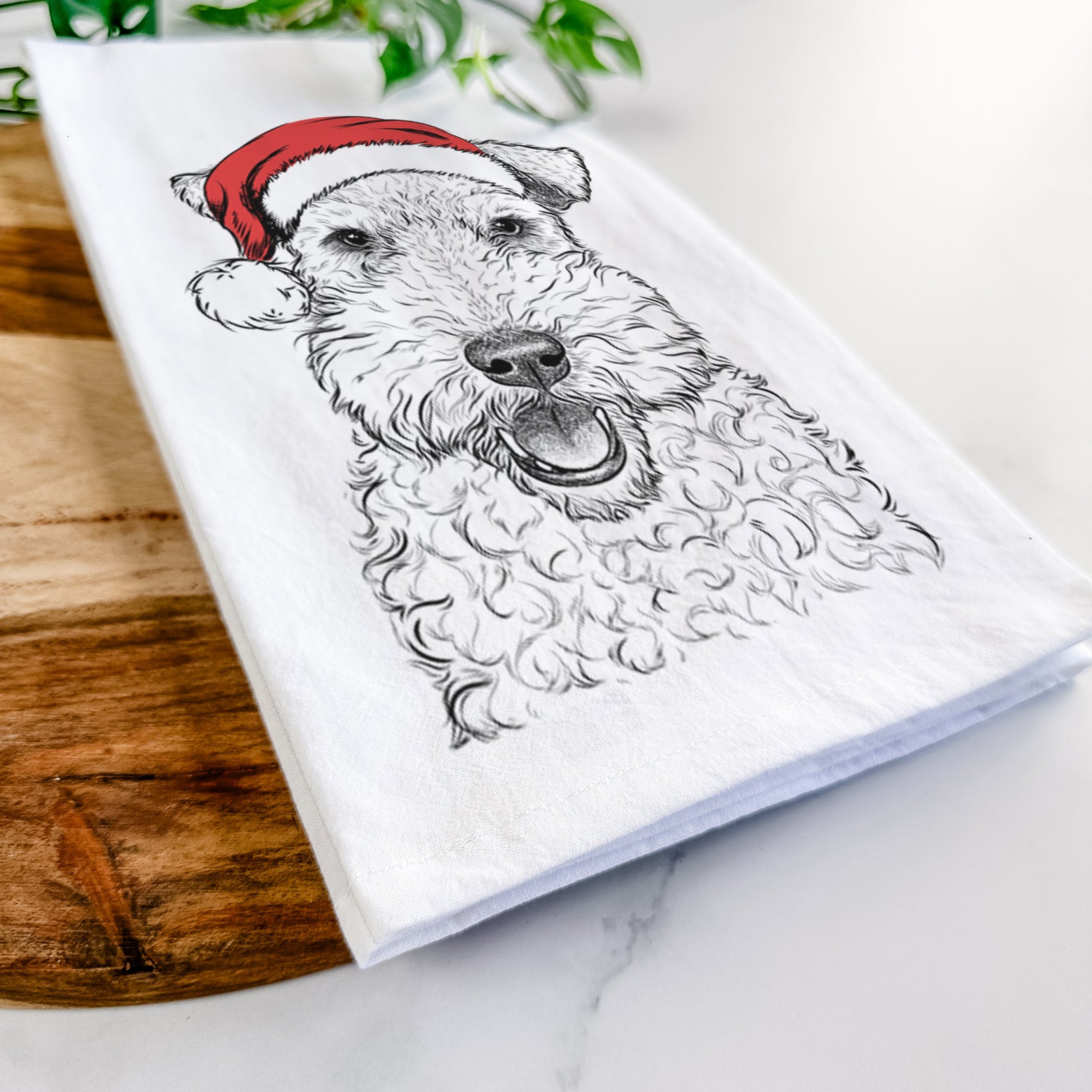 Hand-drawn sketch of Ted the Wire Fox Terrier wearing a Santa hat on a tea towel
