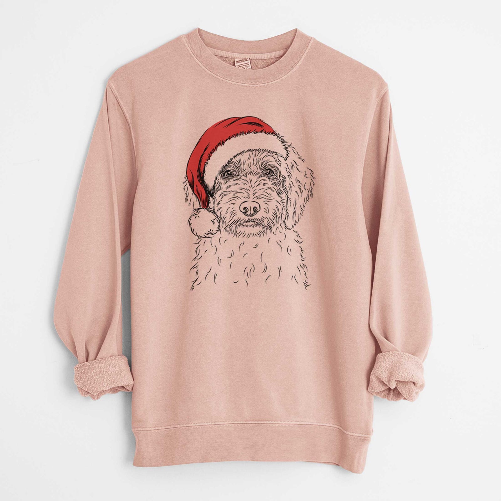 Hand-drawn sketch of Teddy the Labradoodle wearing a Santa hat on a Dusty Pink Unisex pigment dyed crew sweatshirt