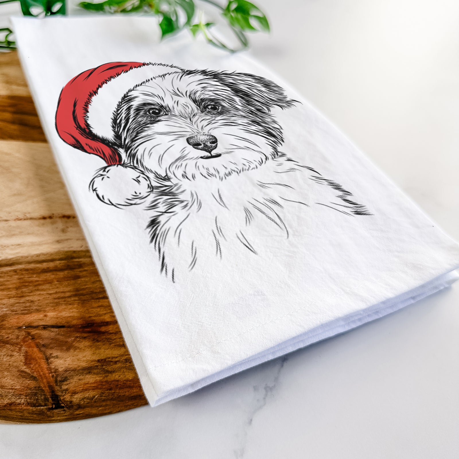Hand-drawn sketch of Teddy the Havanese wearing a Santa hat on a tea towel