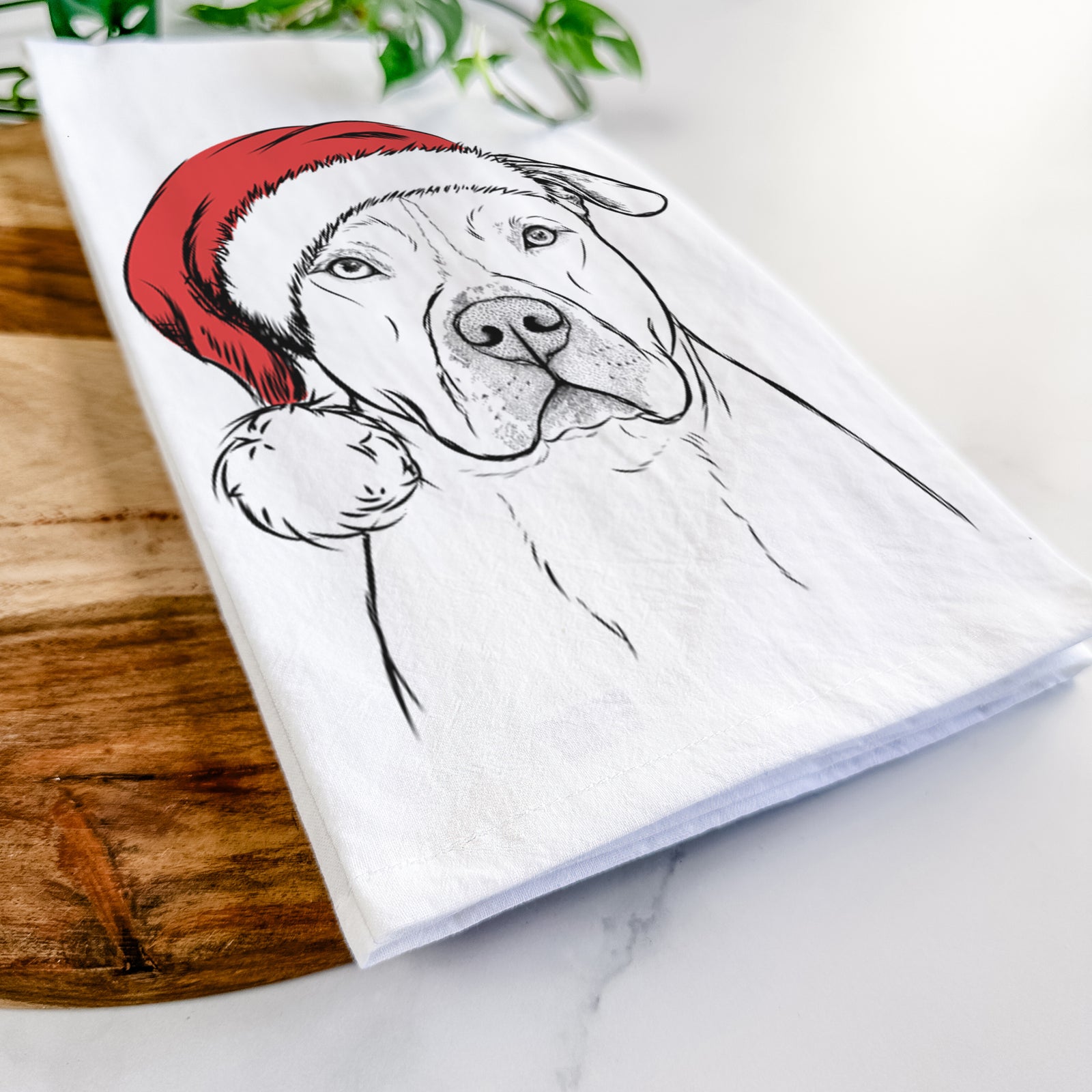Hand-drawn sketch of Teddy Jam the Pitbull wearing a Santa hat on a tea towel