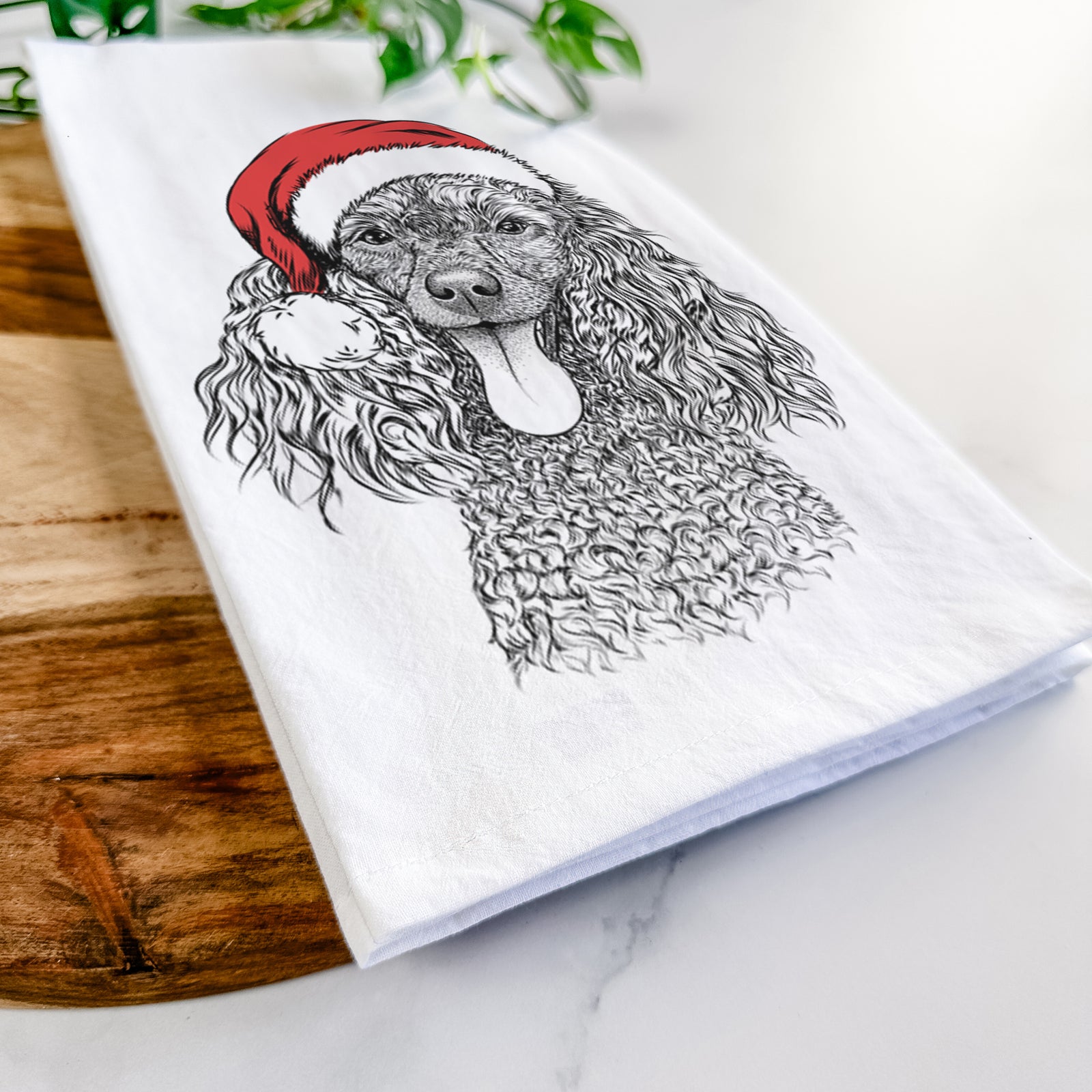 Hand-drawn sketch of Teddy the Mini Poodle wearing a Santa hat on a tea towel