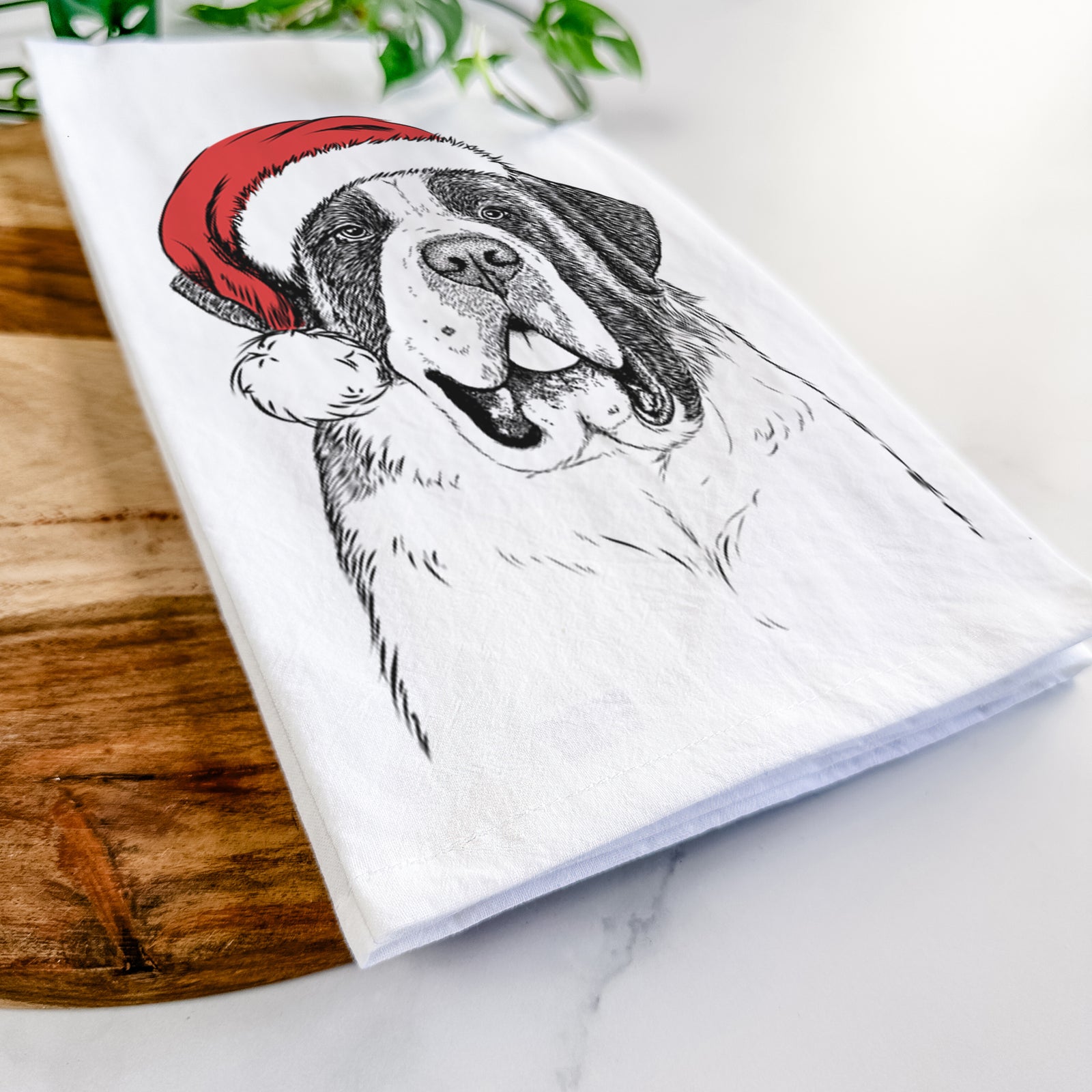 Hand-drawn sketch of Thor the Saint Bernard wearing a Santa hat on a tea towel