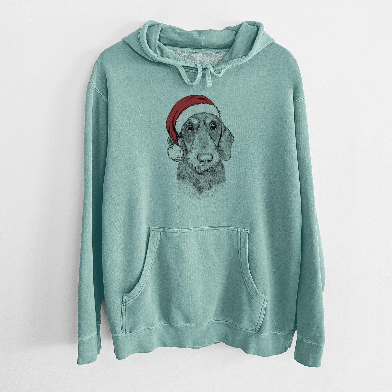 Hand-drawn sketch of Truman the Wirehaired Dachshund wearing a Santa hat on a Mint Unisex pigment dyed hoodie