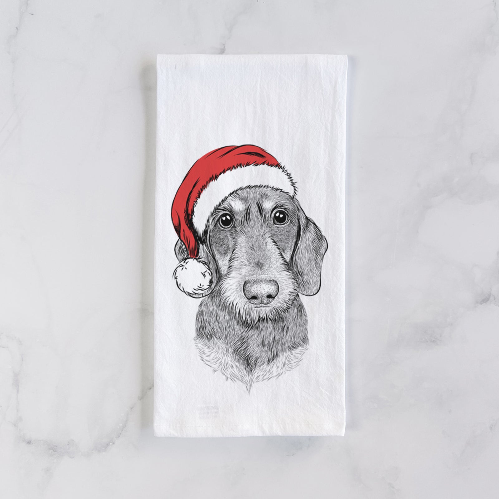 Hand-drawn sketch of Truman the Wirehaired Dachshund wearing a Santa hat on a tea towel