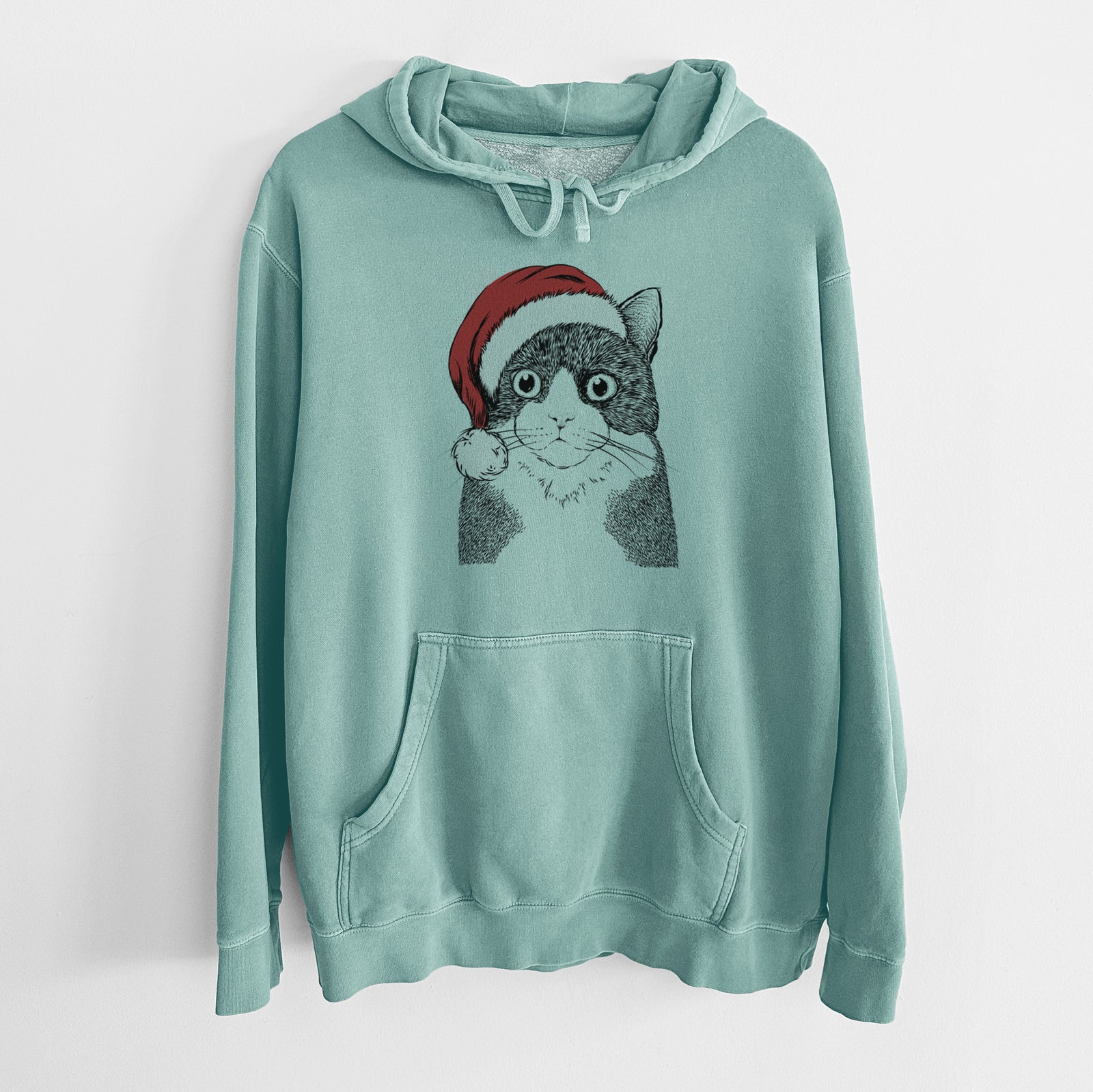Hand-drawn sketch of Tux the Tuxedo Cat wearing a Santa hat on a Mint Unisex pigment dyed hoodie