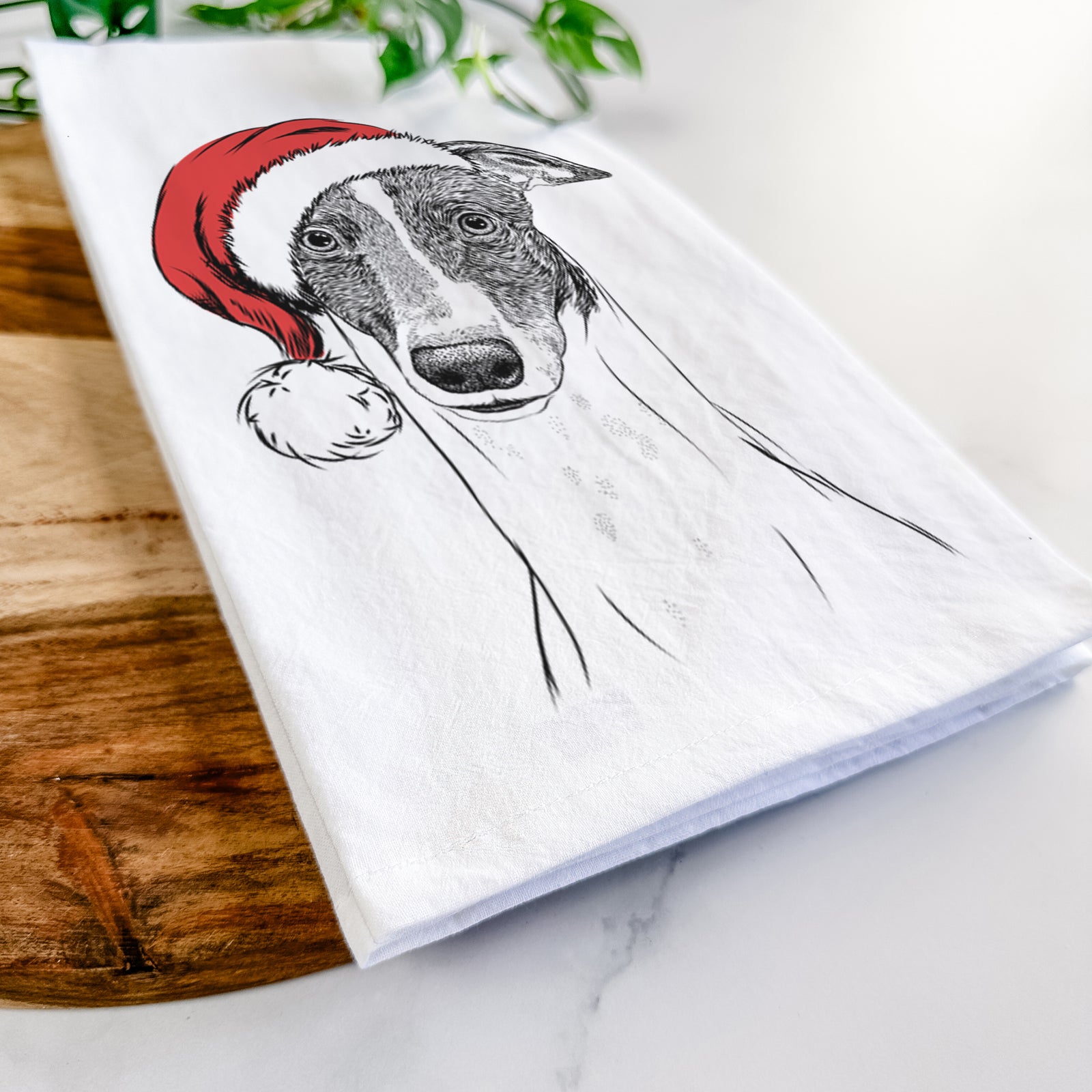 Hand-drawn sketch of Vyncent the Greyhound wearing a Santa hat on a tea towel