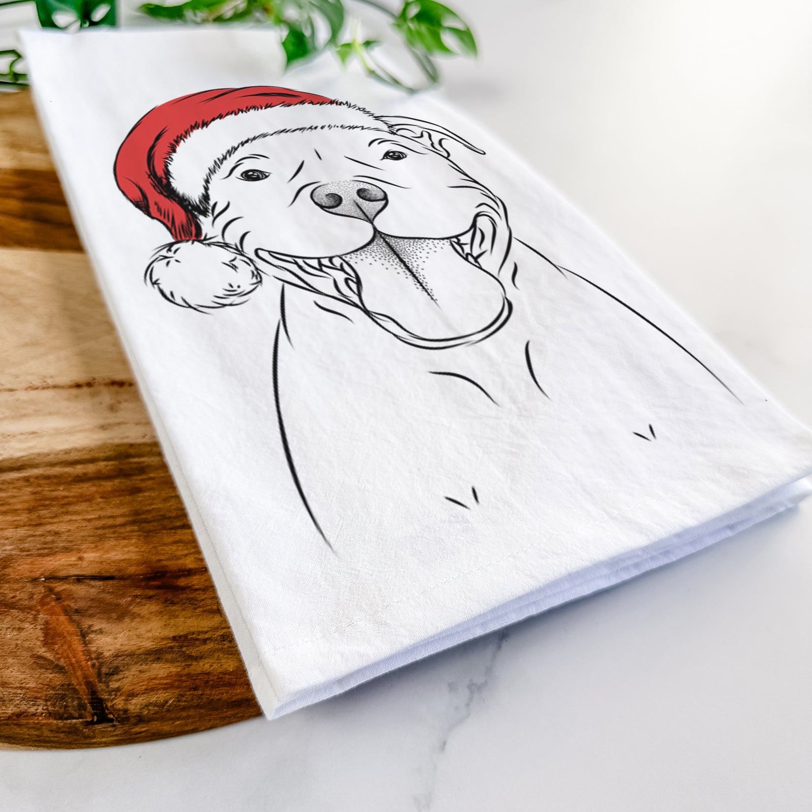 Hand-drawn sketch of Wafer the Staffordshire Bull Terrier wearing a Santa hat on a tea towel