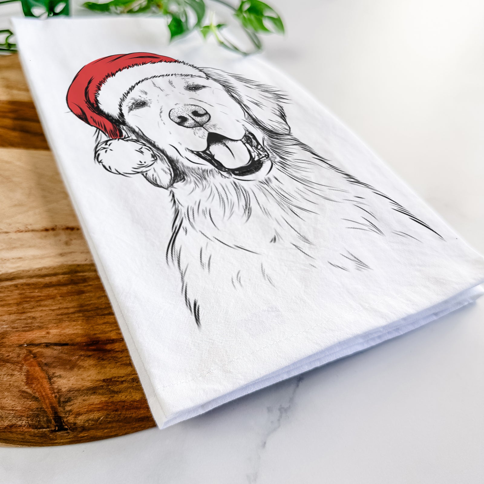 Hand-drawn sketch of Wallace the Golden Retriever wearing a Santa hat on a tea towel