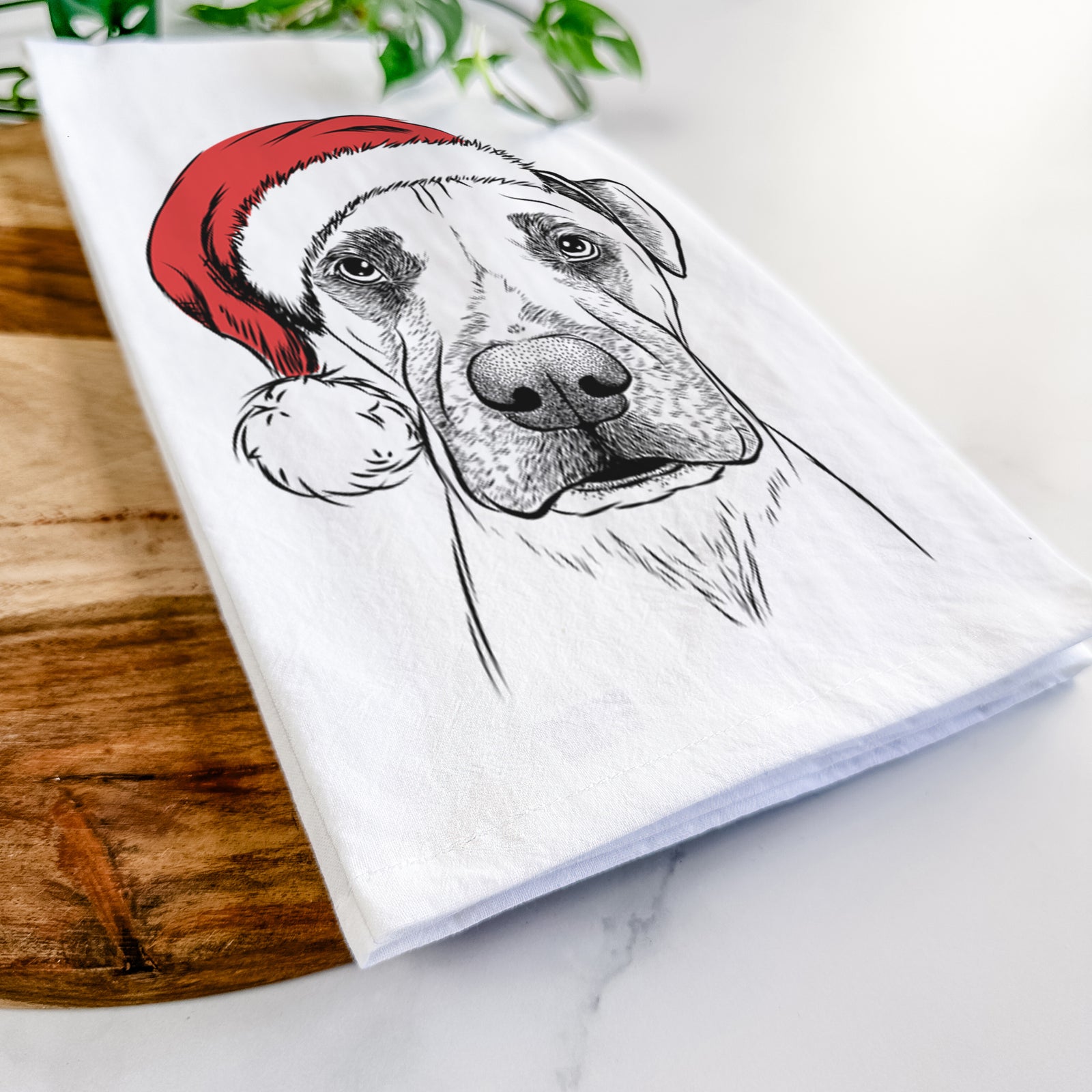 Hand-drawn sketch of Waylon the Boxane wearing a Santa hat on a tea towel