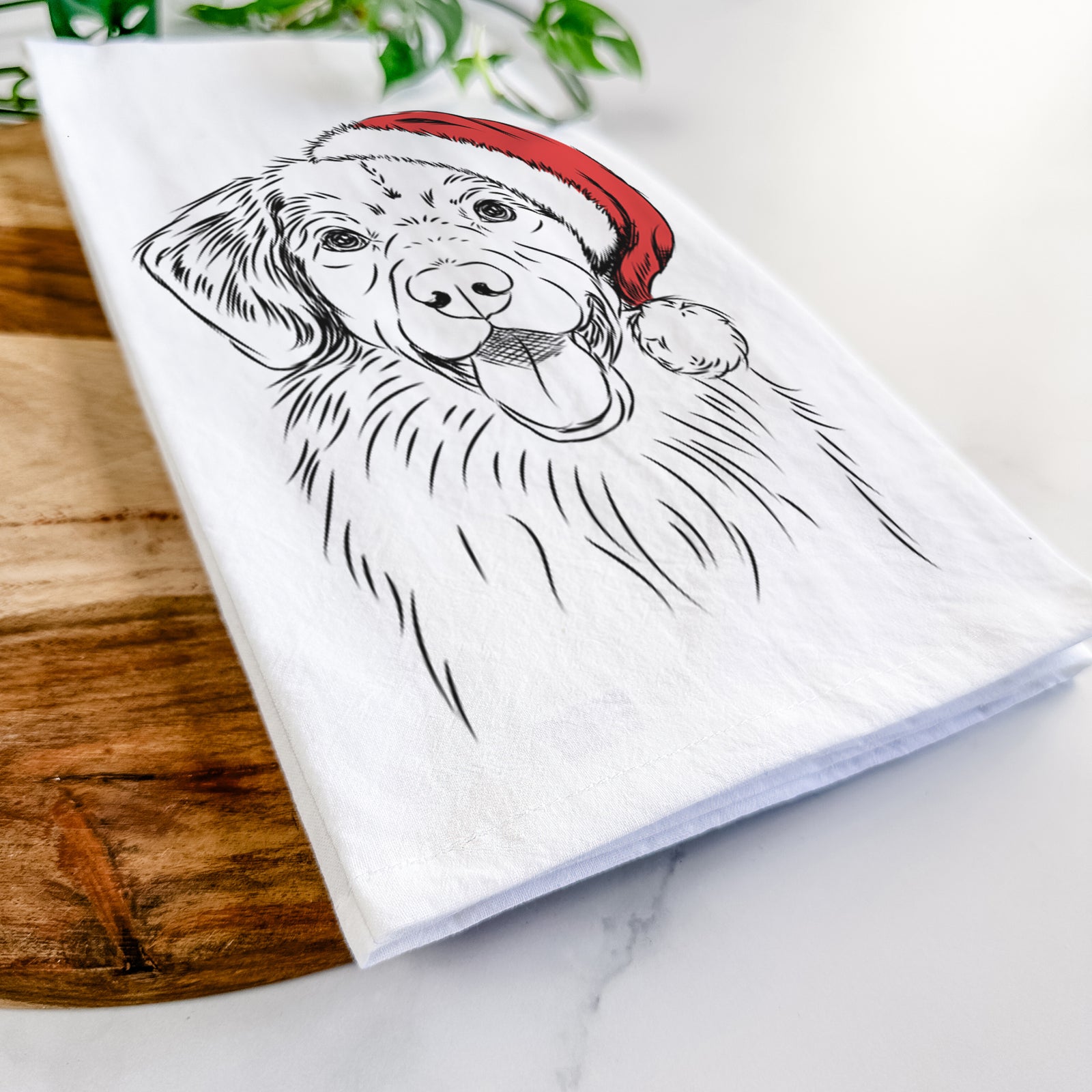 Hand-drawn sketch of Weston the Nova Scotia Duck Tolling Retriever wearing a Santa hat on a tea towel