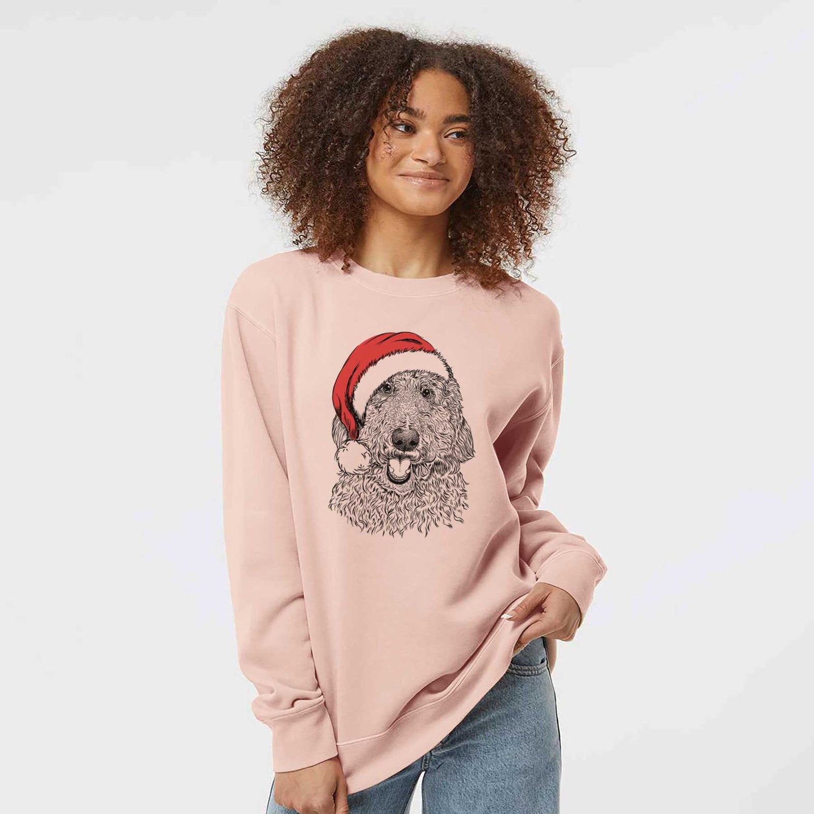 Hand-drawn sketch of Whisper the Goldendoodle wearing a Santa hat on a Dusty Pink Unisex pigment dyed crew sweatshirt