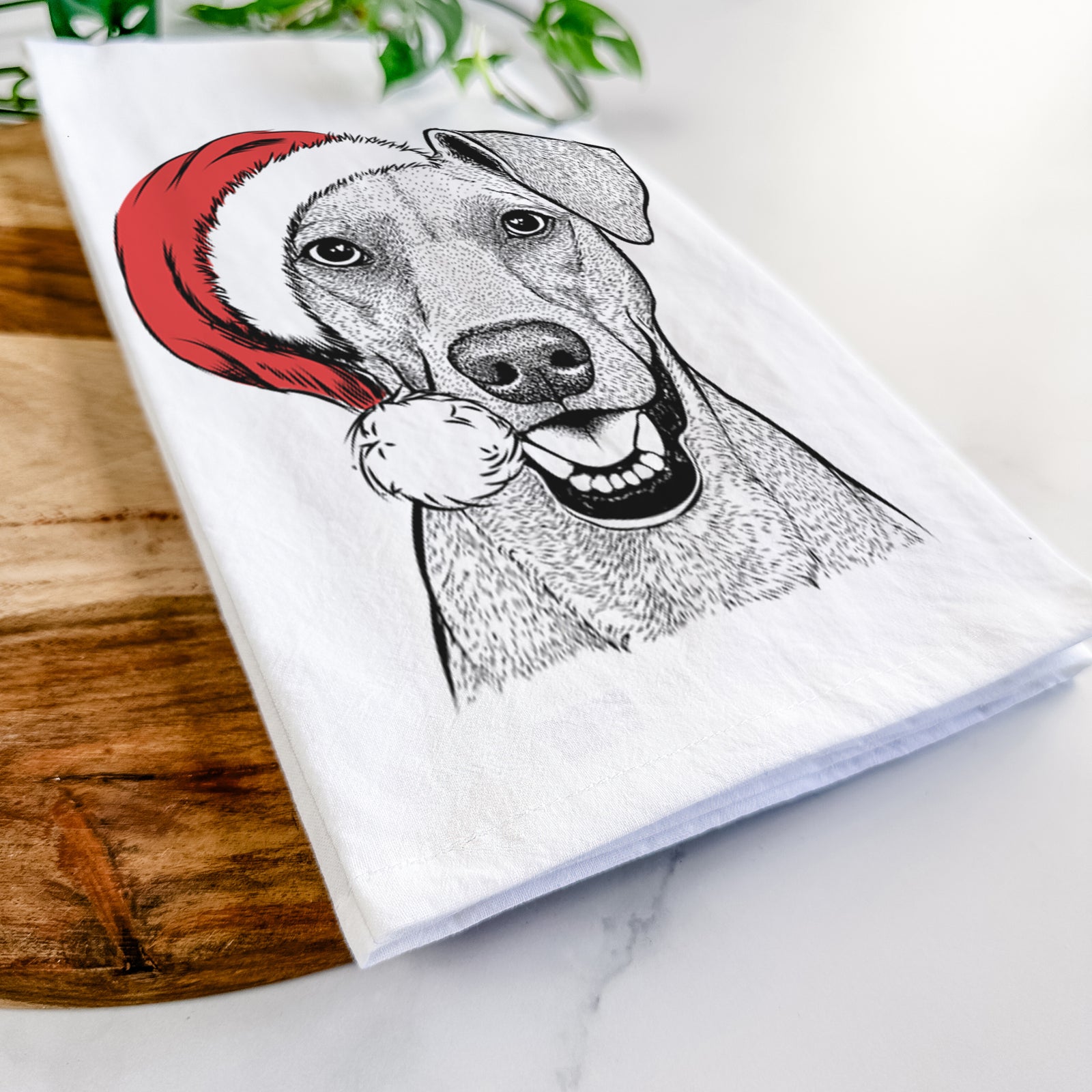 Hand-drawn sketch of Willow the German Pinscher wearing a Santa hat on a tea towel