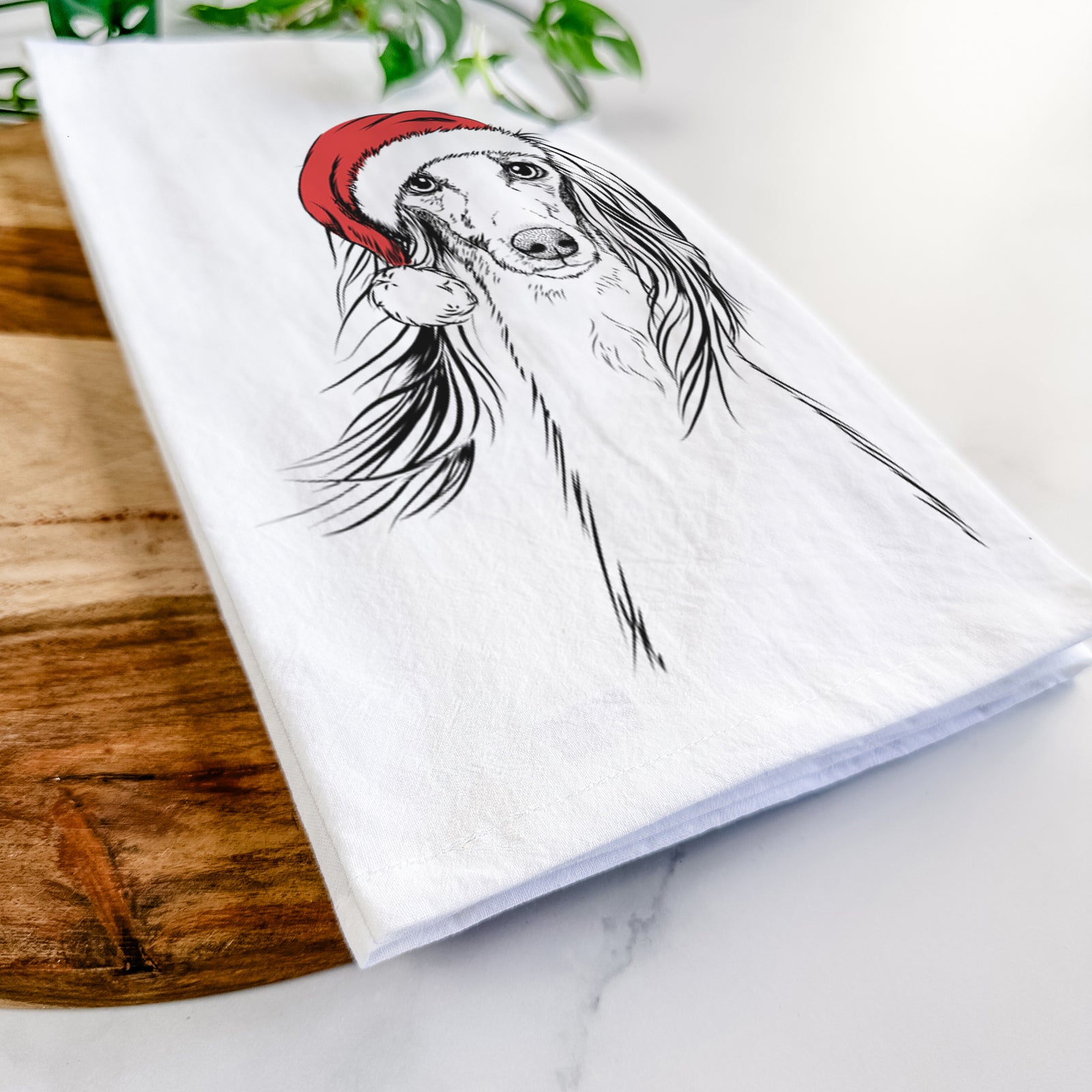 Hand-drawn sketch of Zahra the Saluki wearing a Santa hat on a tea towel