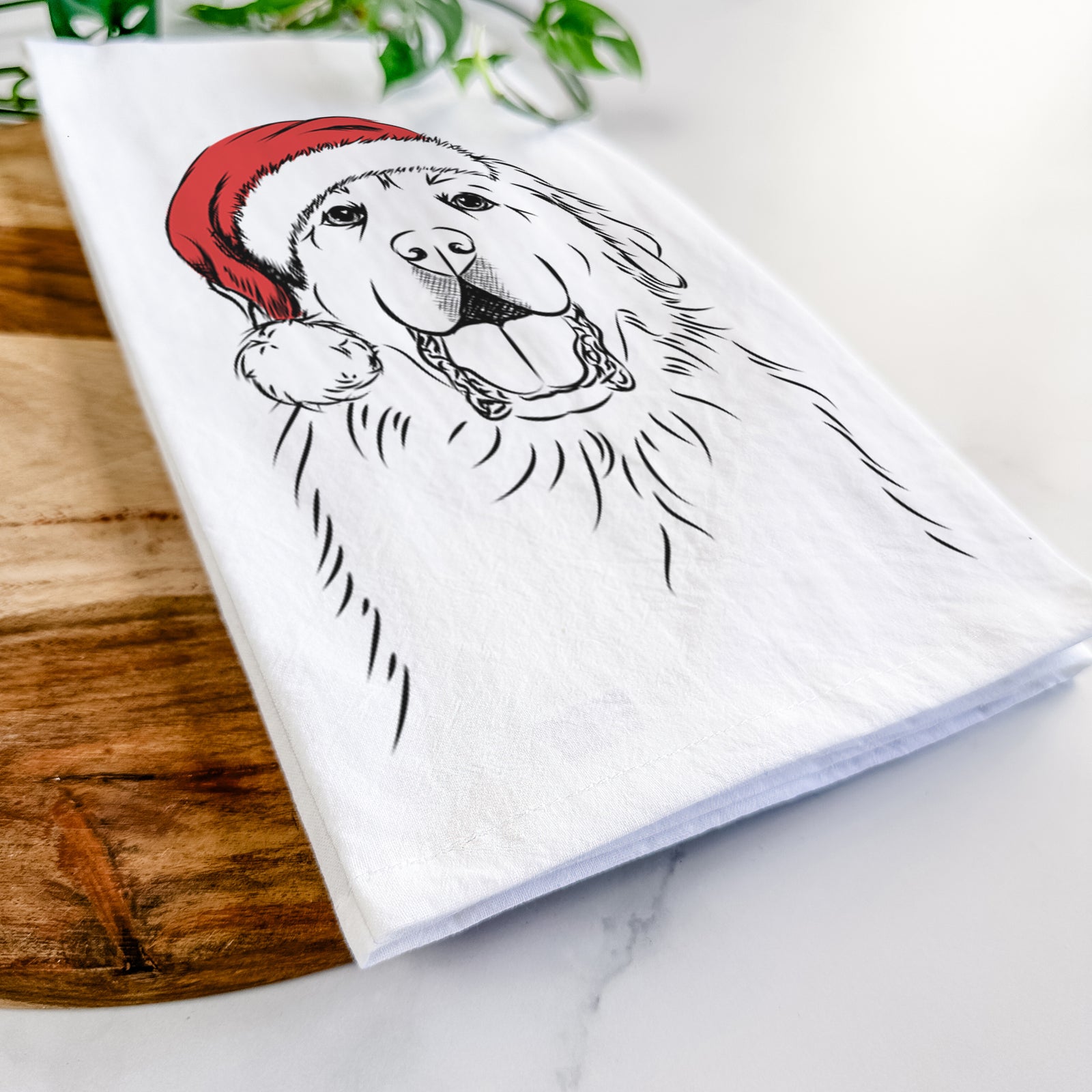 Hand-drawn sketch of Zeus the Great Pyrenees wearing a Santa hat on a tea towel