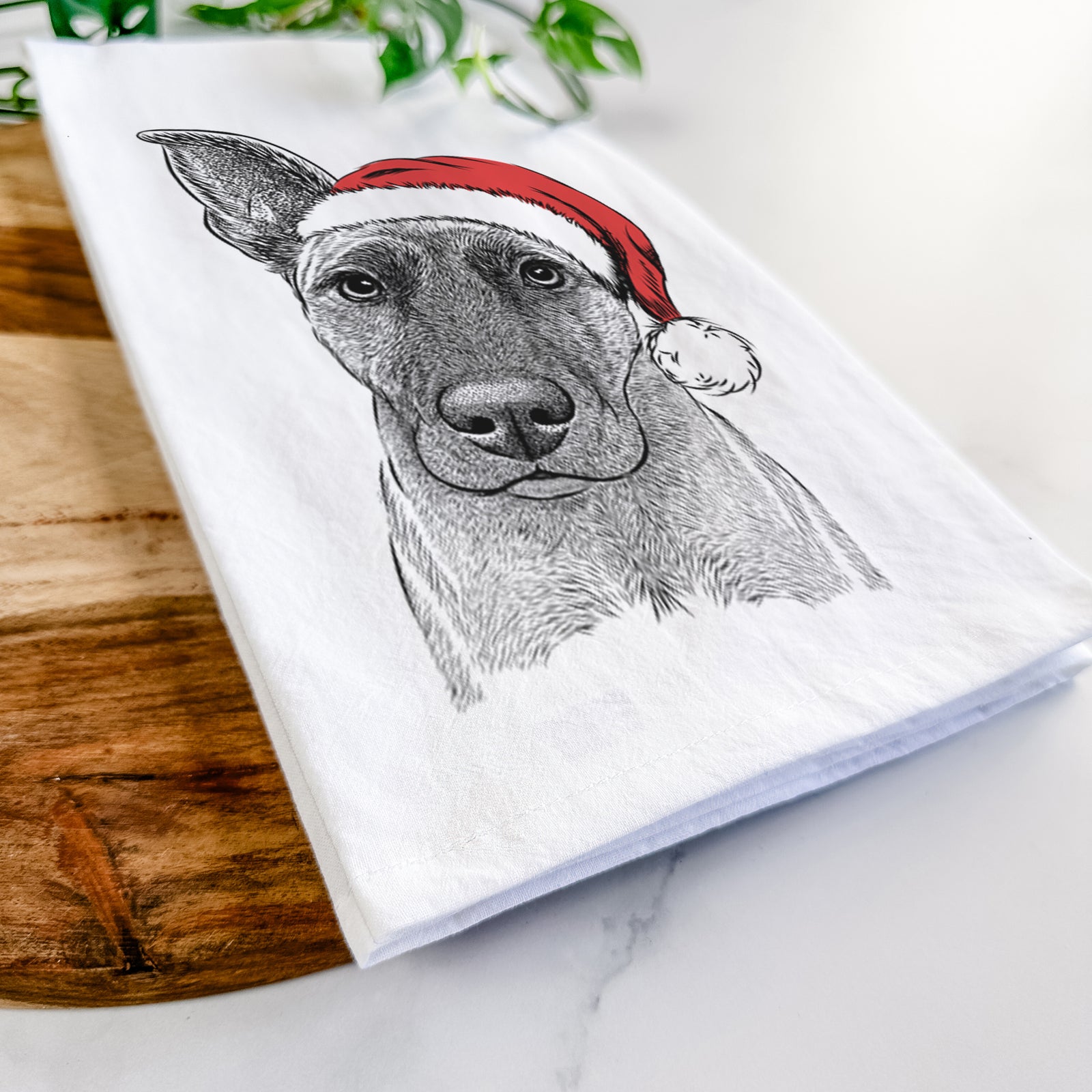 Hand-drawn sketch of Zoey the Mixed Breed wearing a Santa hat on a tea towel