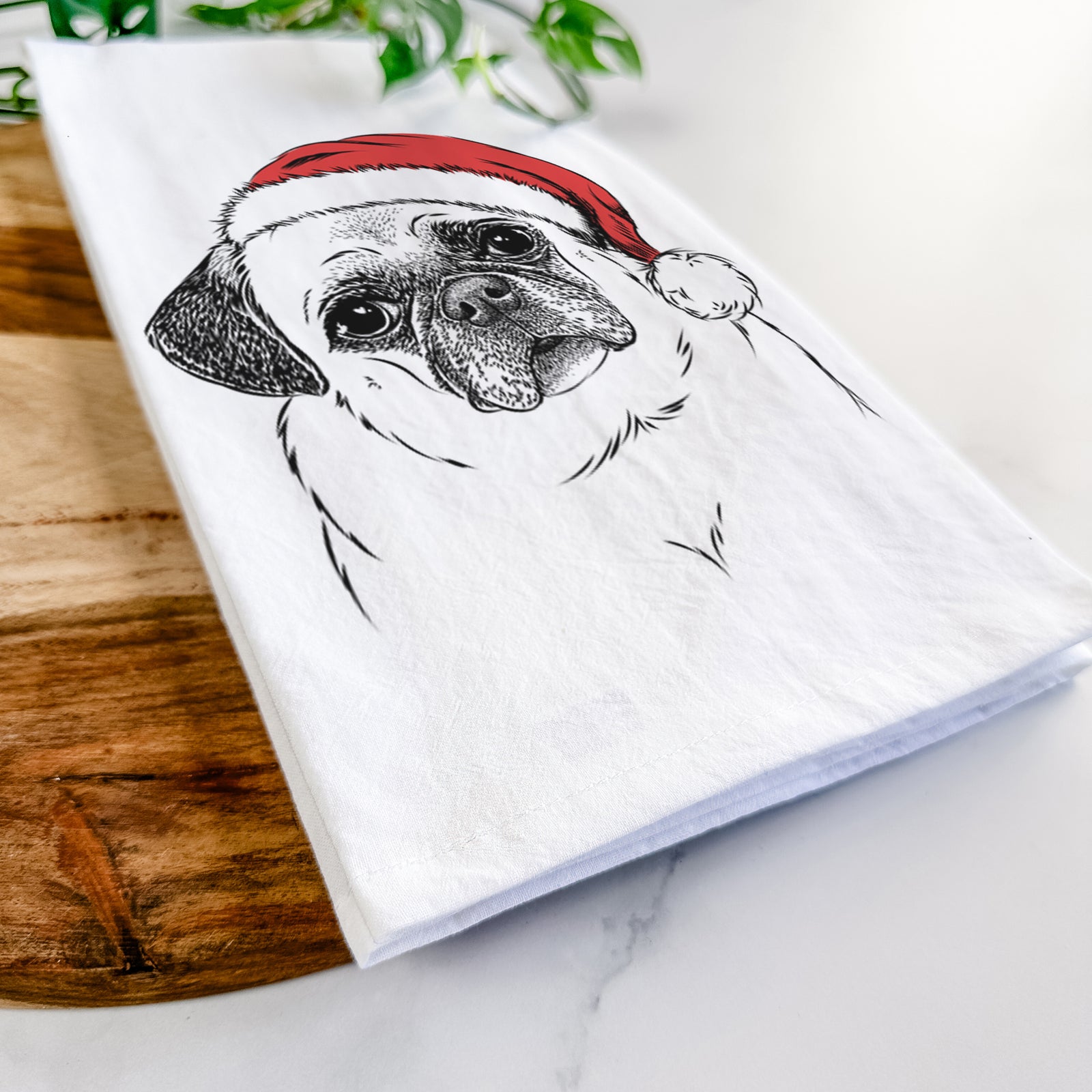 Hand-drawn sketch of Zoey the Pug wearing a Santa hat on a tea towel